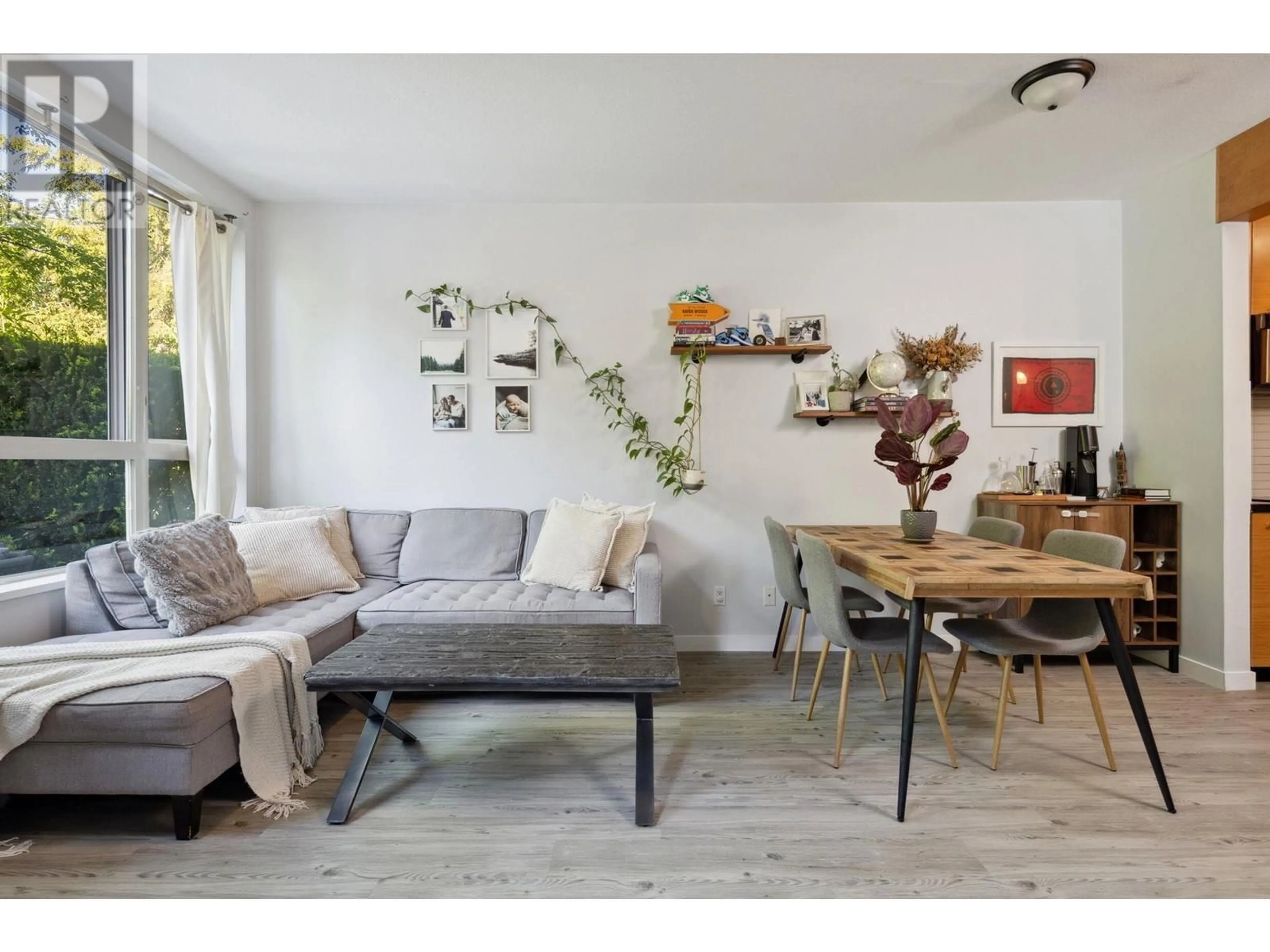 Living room with furniture, wood/laminate floor for 210 - 560 RAVEN WOODS DRIVE, North Vancouver British Columbia V7V1H1