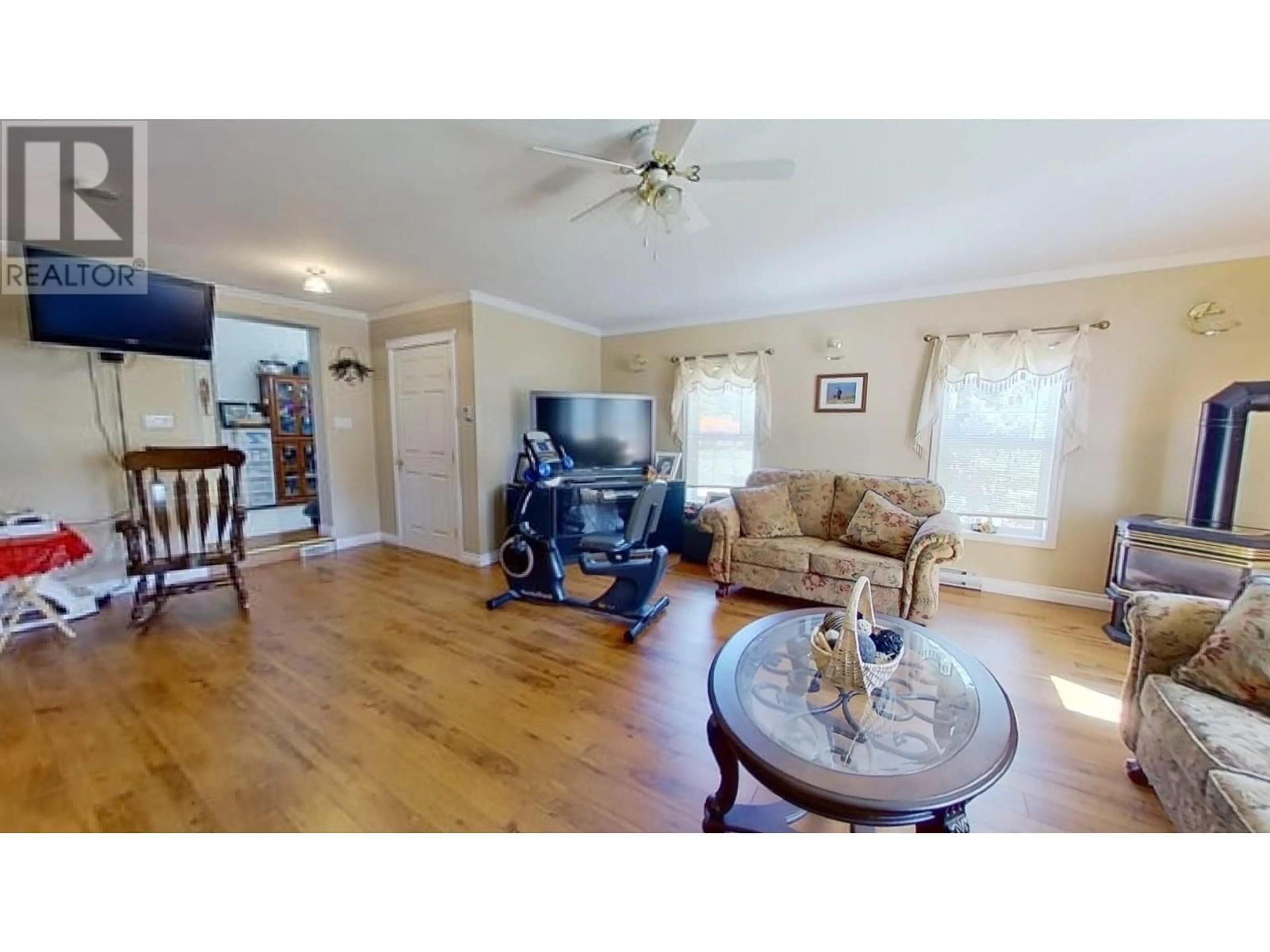 Living room with furniture, wood/laminate floor for 10874 261 ROAD, Fort St. John British Columbia V1J4J2