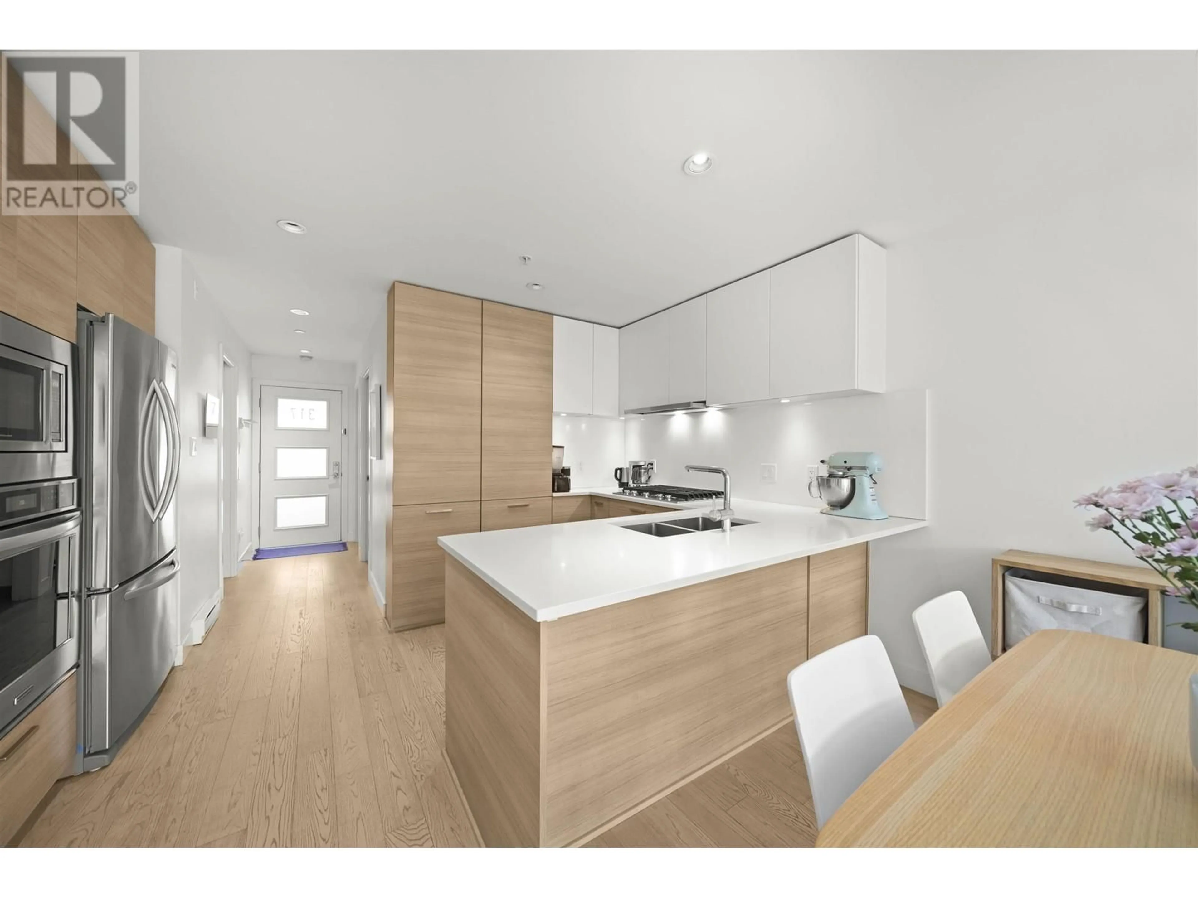 Contemporary kitchen, wood/laminate floor for 317 - 3456 COMMERCIAL STREET, Vancouver British Columbia V5N4E9