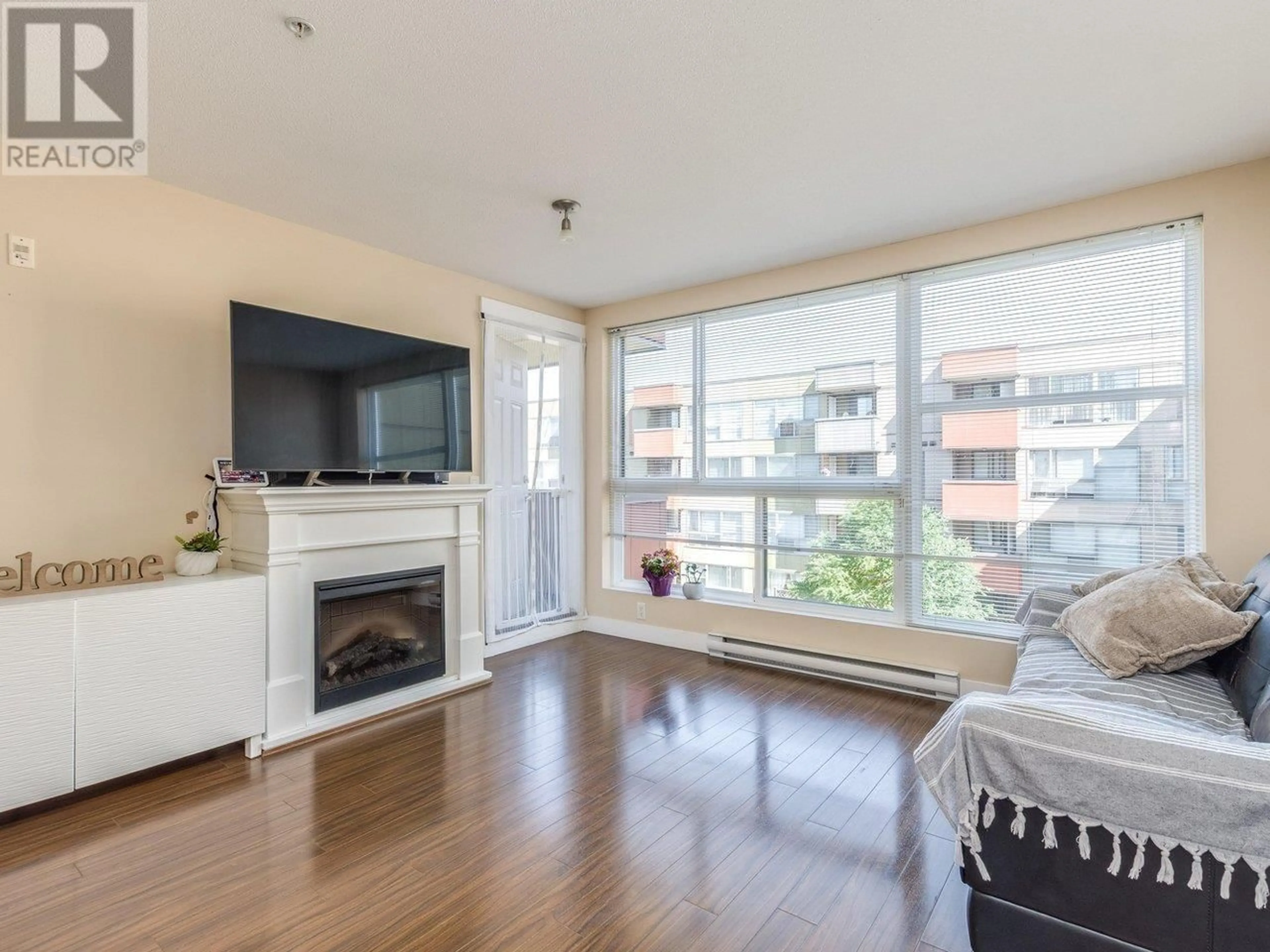 Living room with furniture, wood/laminate floor for 313 - 12075 228 STREET, Maple Ridge British Columbia V2X6M2