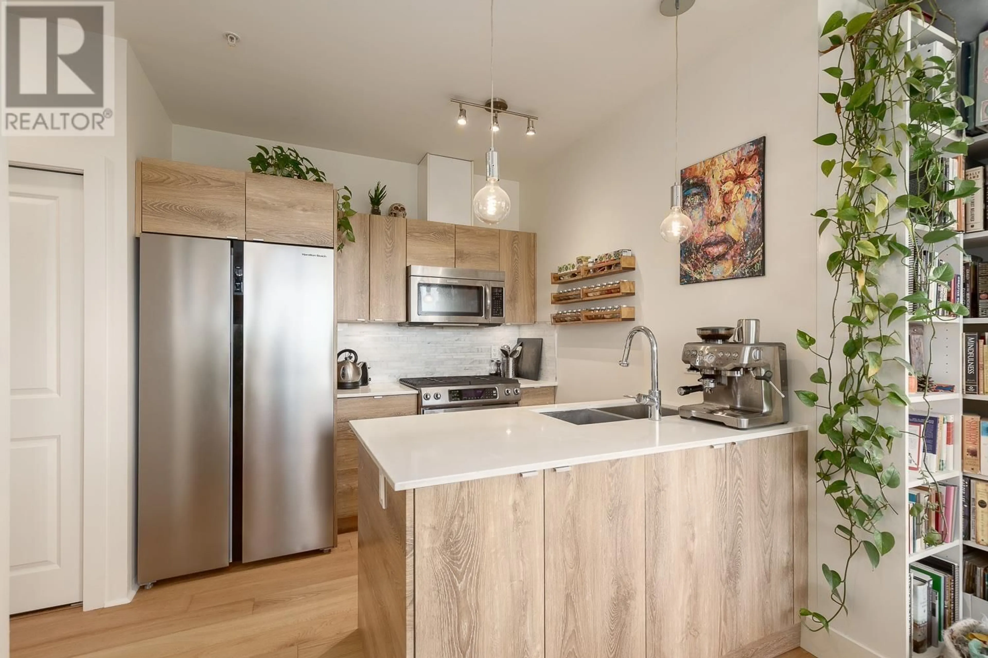 Open concept kitchen, wood/laminate floor for 313 - 2250 COMMERCIAL DRIVE, Vancouver British Columbia V5N5P9