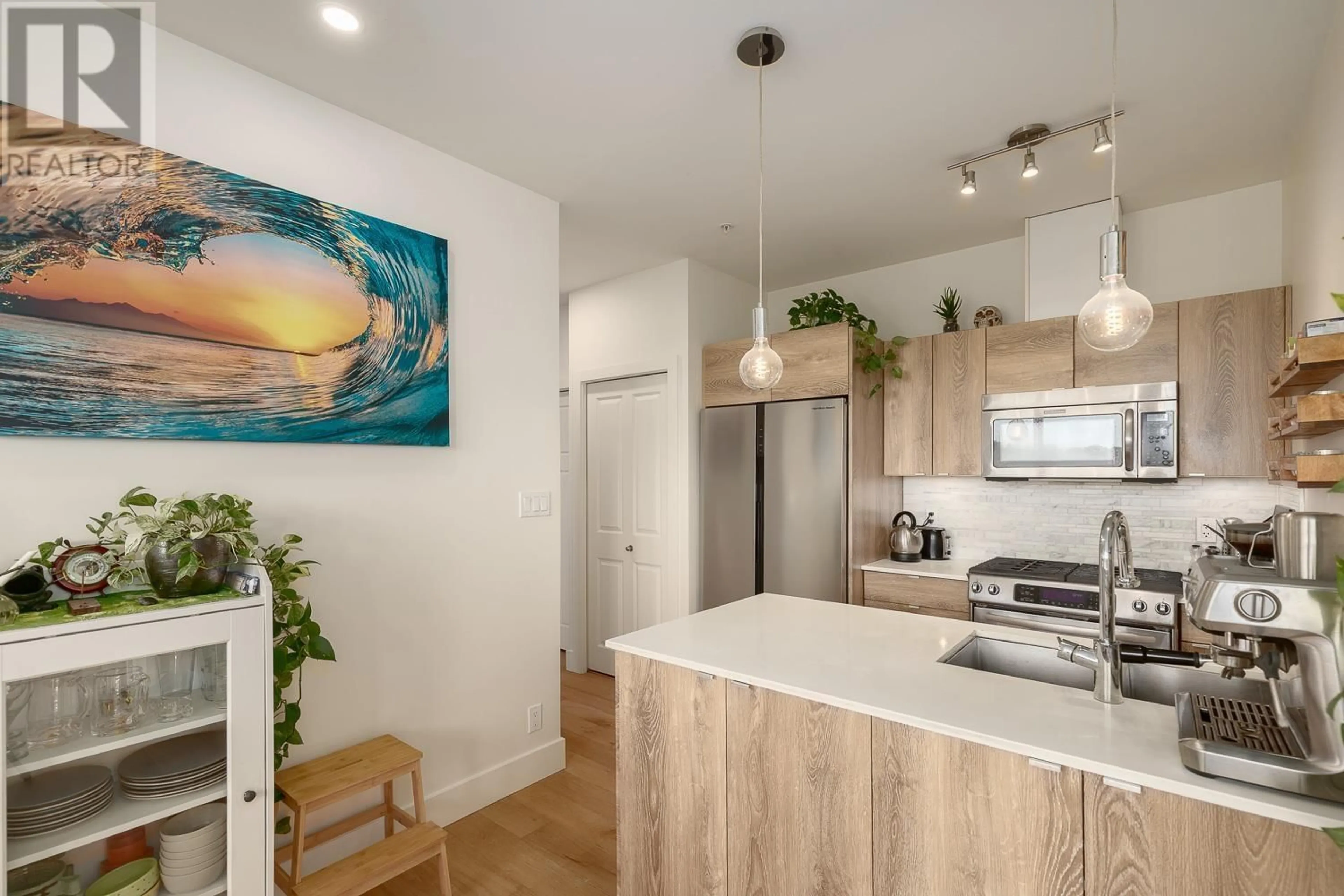 Open concept kitchen, wood/laminate floor for 313 - 2250 COMMERCIAL DRIVE, Vancouver British Columbia V5N5P9