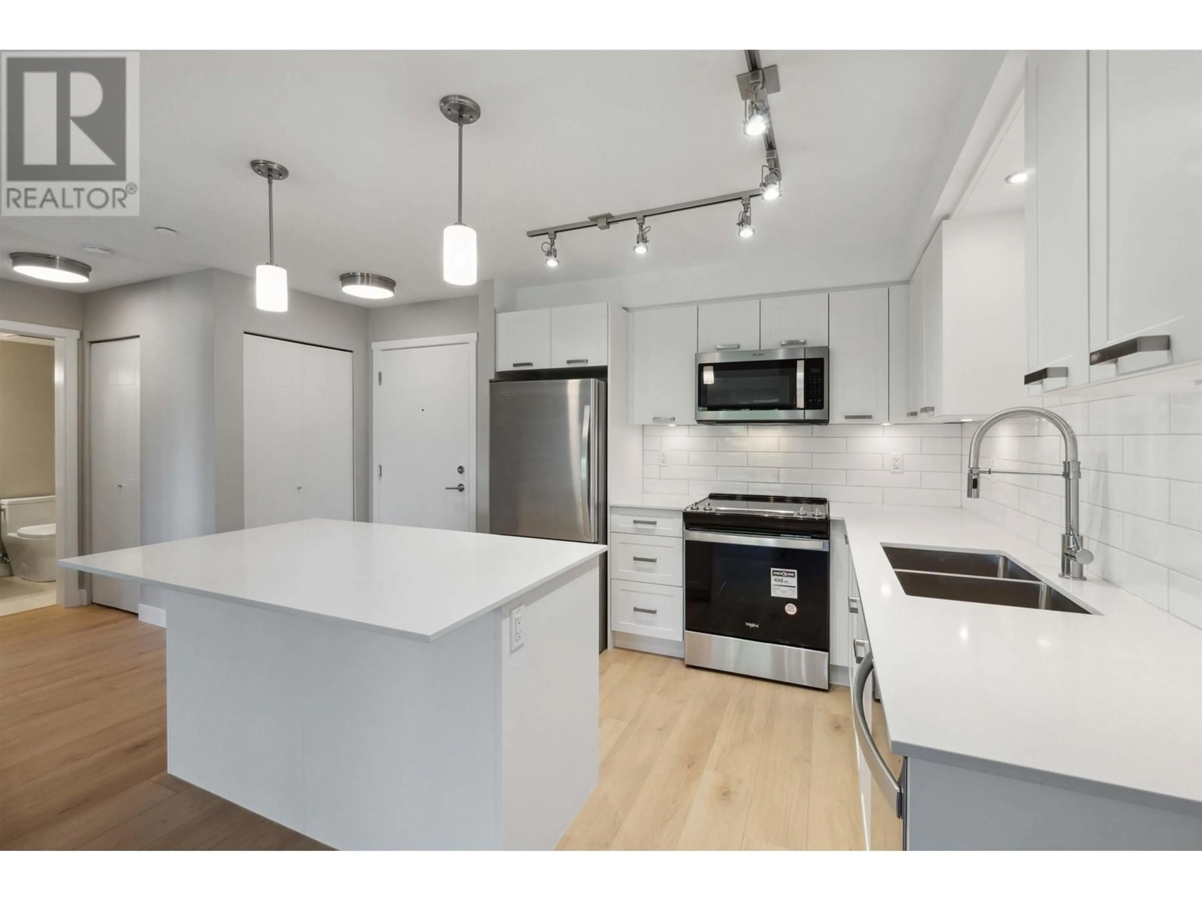 Open concept kitchen, wood/laminate floor for 302 - 22562 121 AVENUE, Maple Ridge British Columbia V2X3Y8