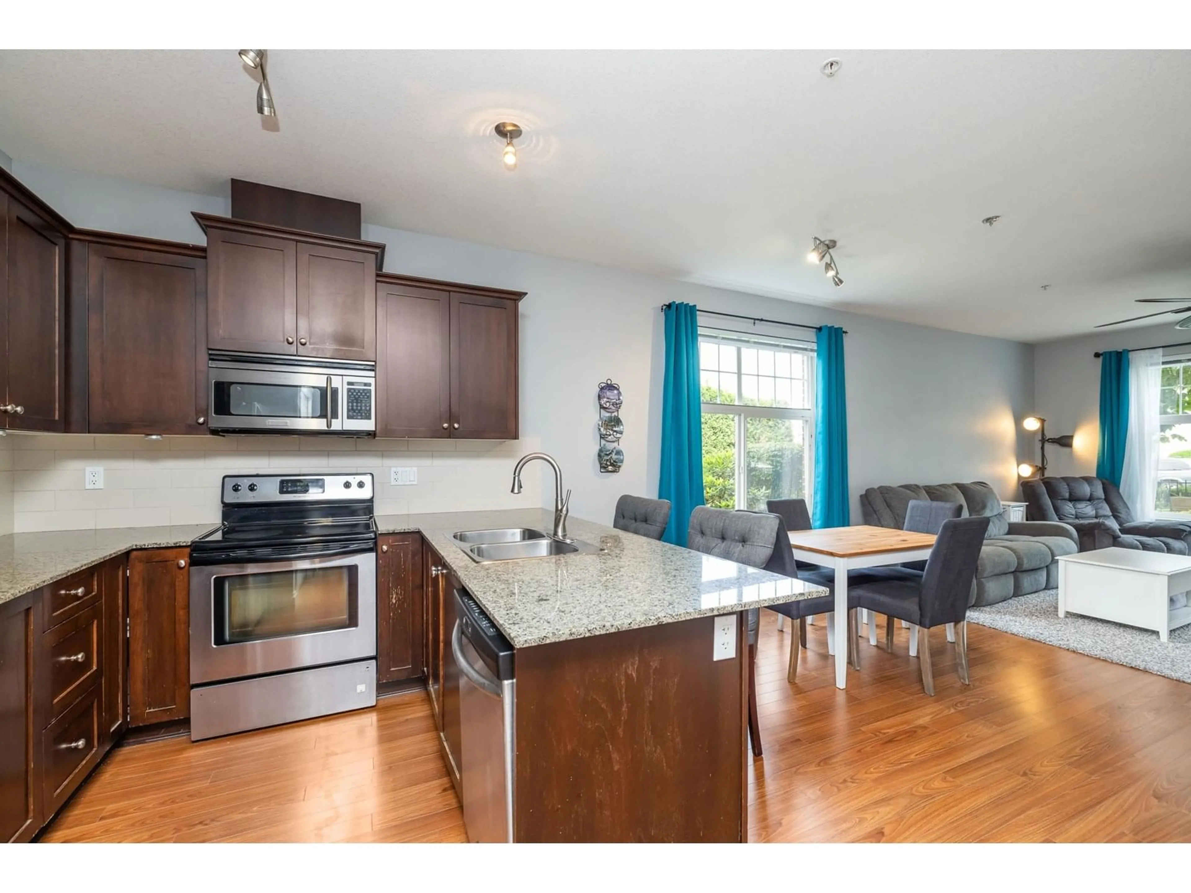 Open concept kitchen, wood/laminate floor for 111 - 17712 57A, Surrey British Columbia V3S1J1