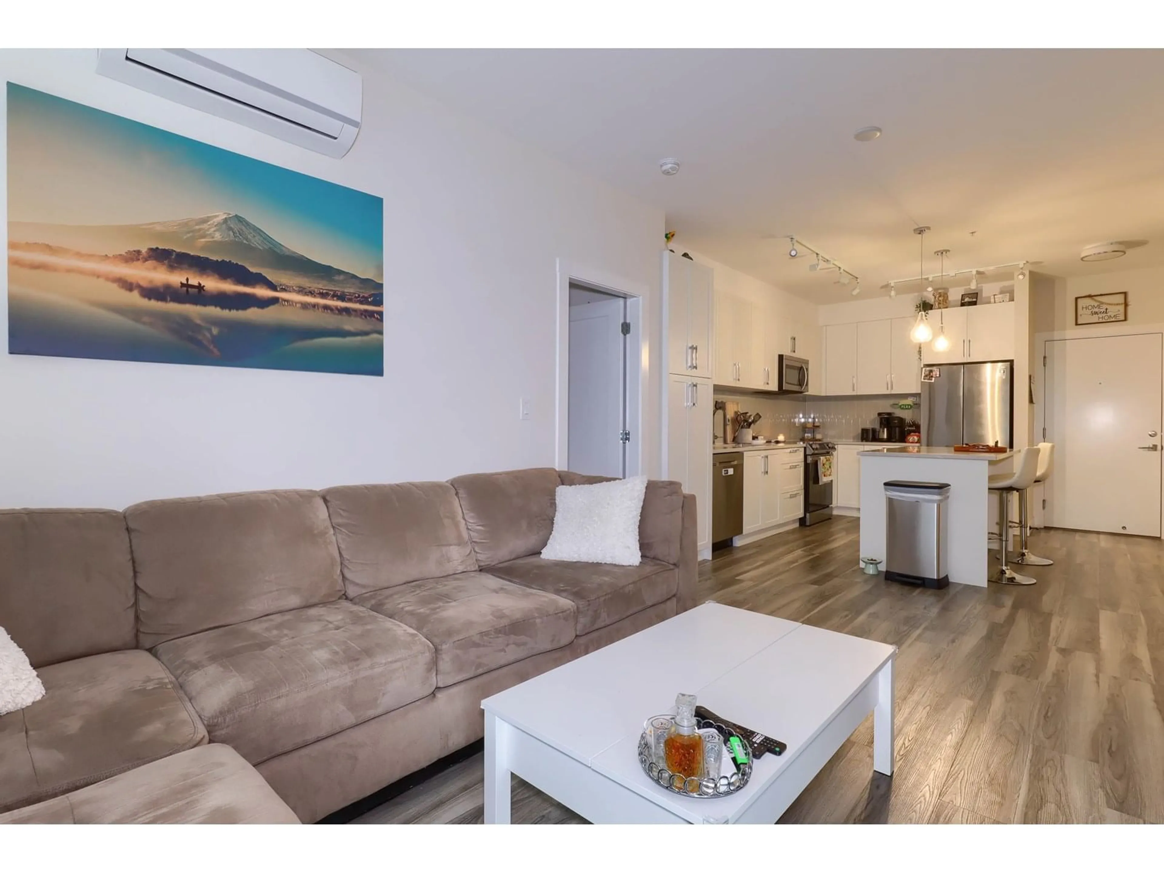 Living room with furniture, wood/laminate floor for 307 - 20356 72B, Langley British Columbia V2Y4J9
