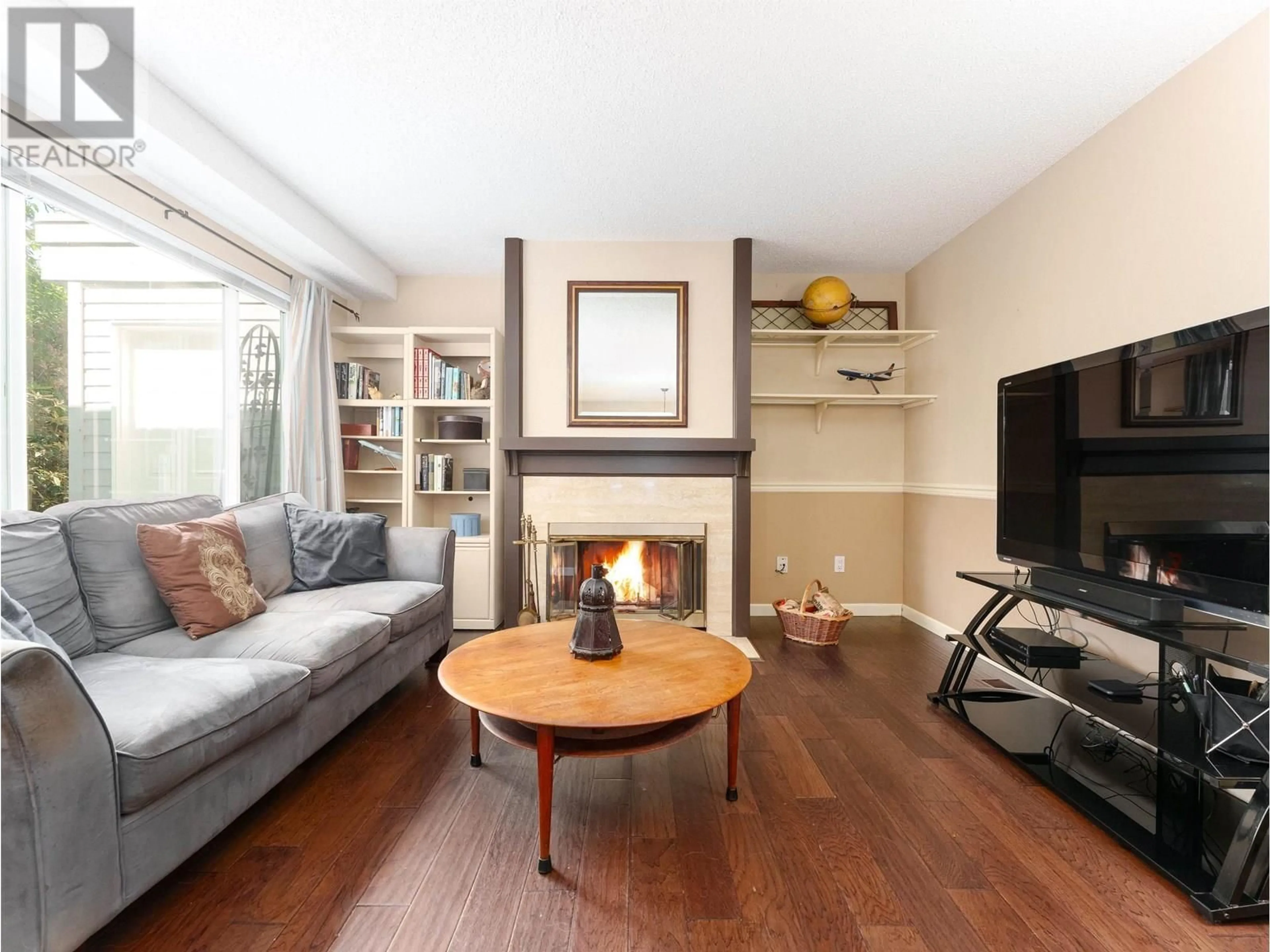 Living room with furniture, wood/laminate floor for 8226 VIVALDI PLACE, Vancouver British Columbia V5S4G6