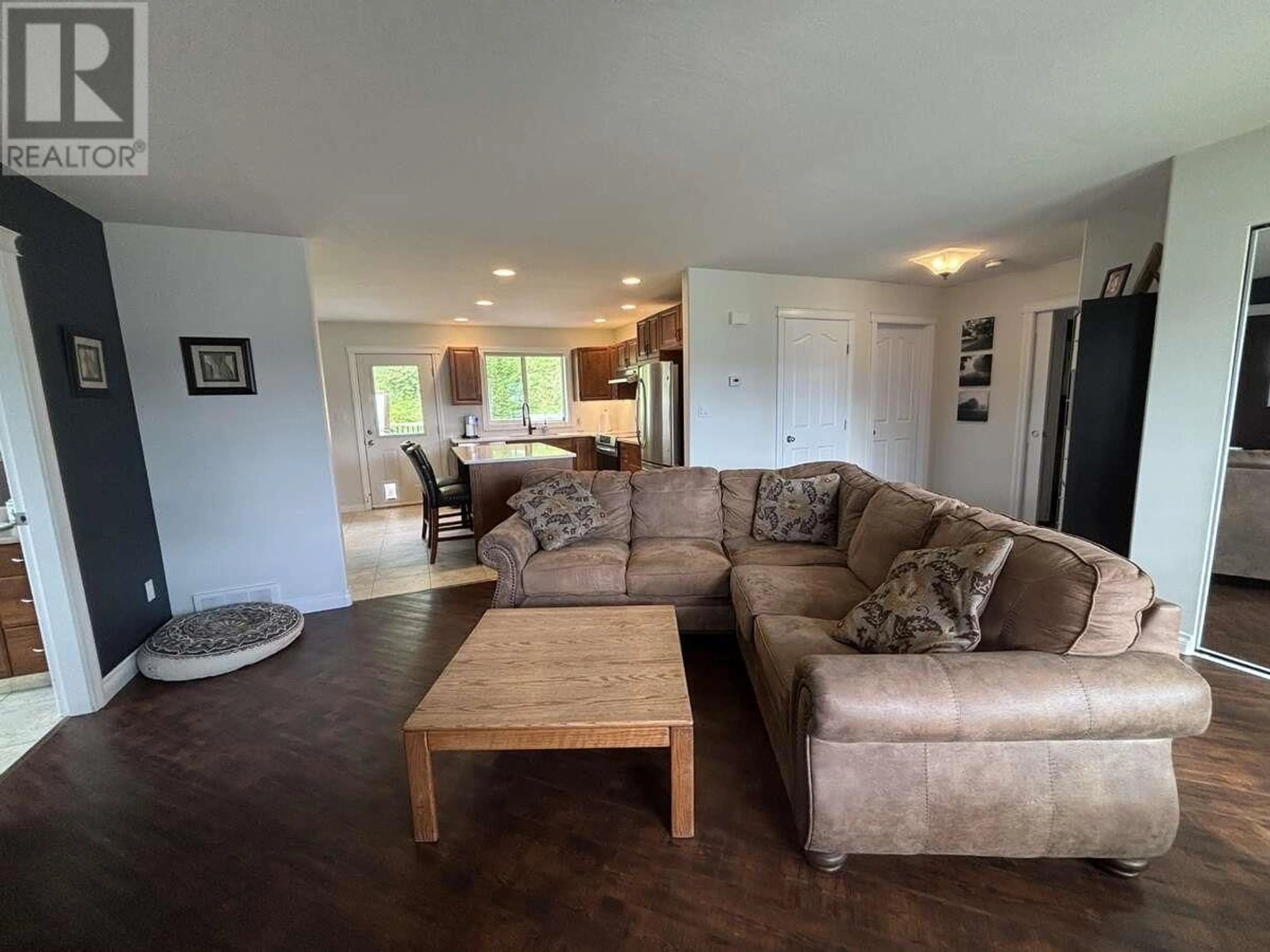 Living room with furniture, wood/laminate floor for 211 NICKEL RIDGE AVENUE, Quesnel British Columbia V2J6P6