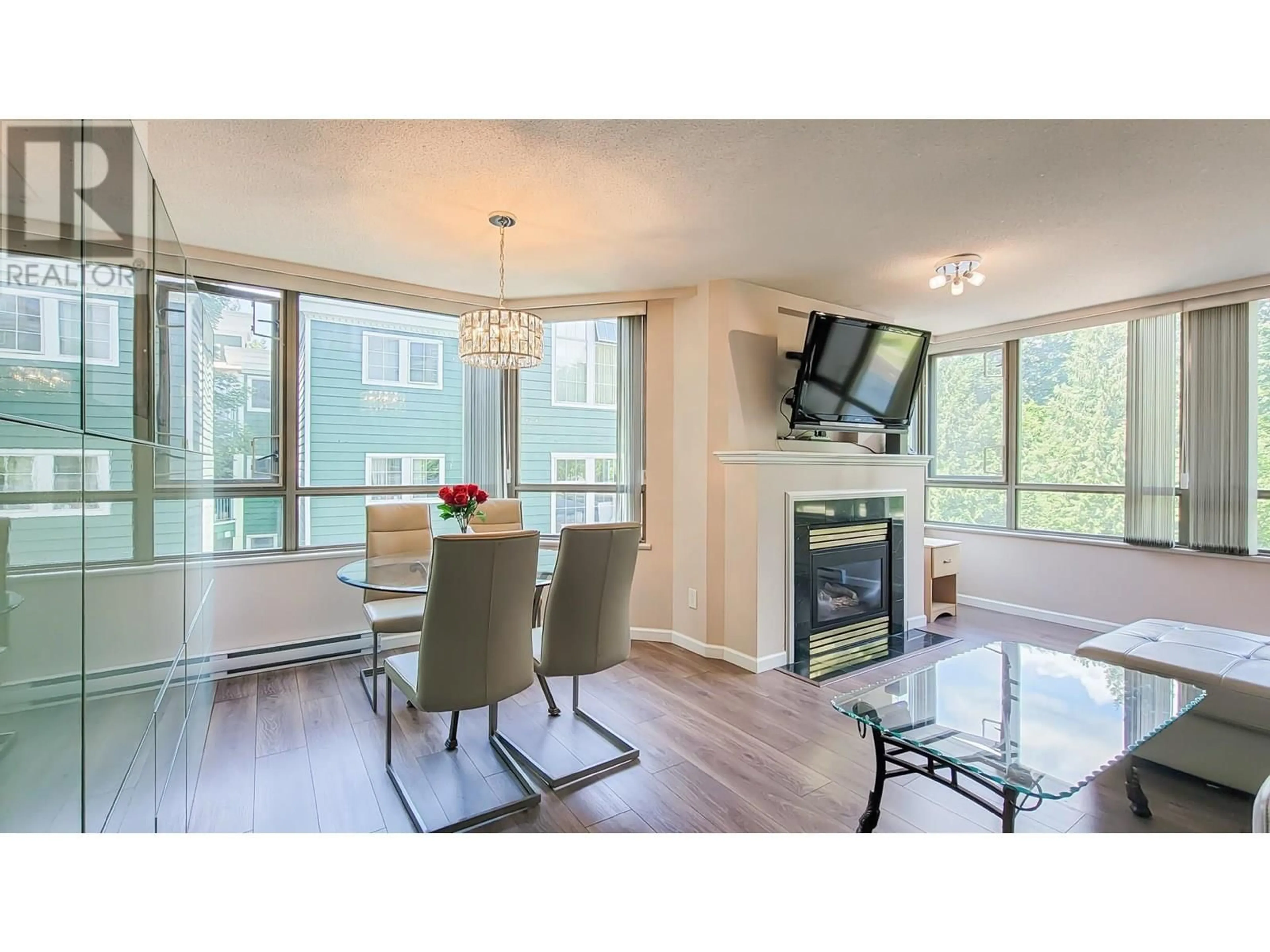 Living room with furniture, wood/laminate floor for 203 - 3070 GUILDFORD WAY, Coquitlam British Columbia V3B7R8