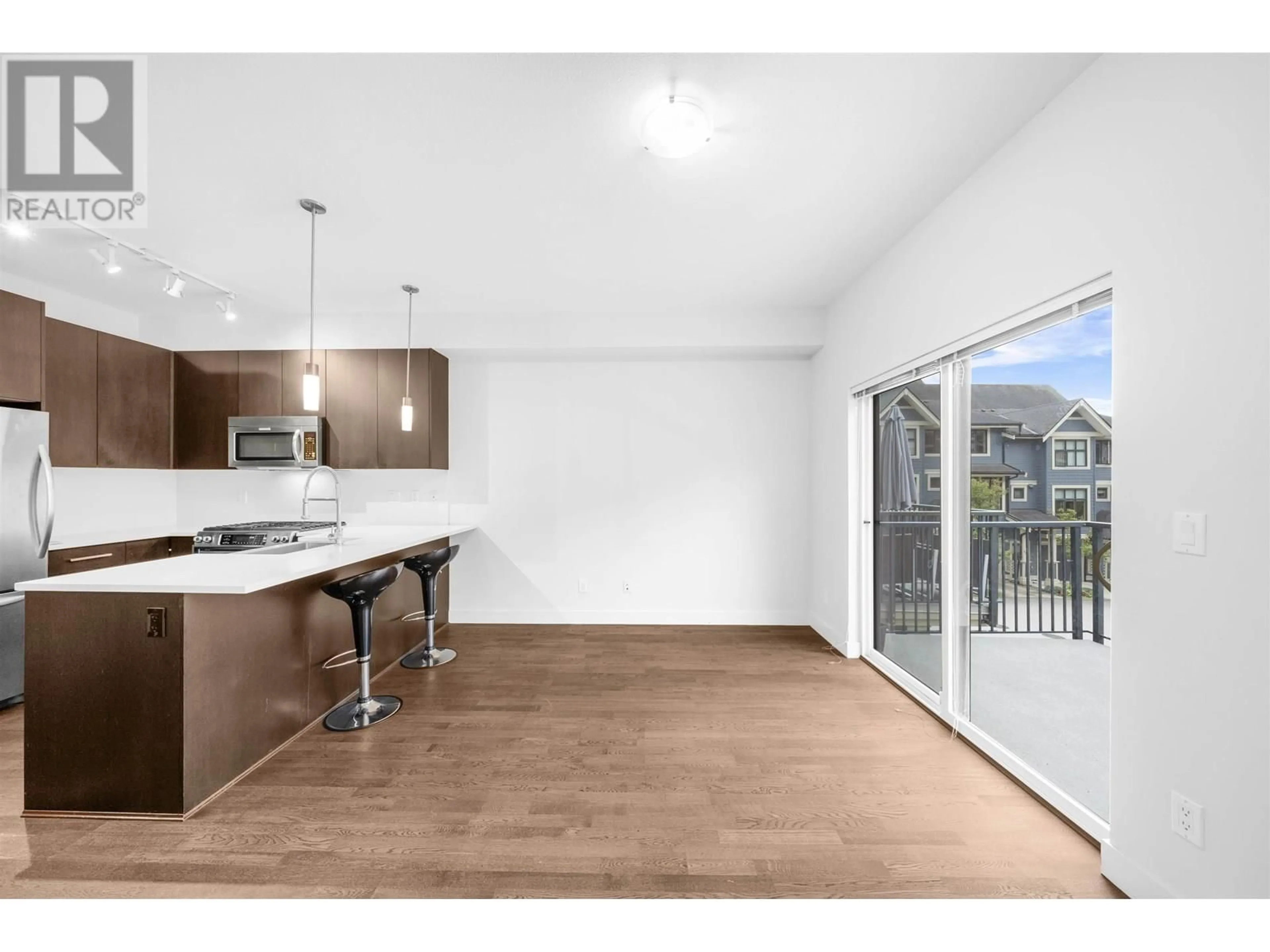 Open concept kitchen, wood/laminate floor for 703 - 8485 NEW HAVEN CLOSE, Burnaby British Columbia V5J0B7