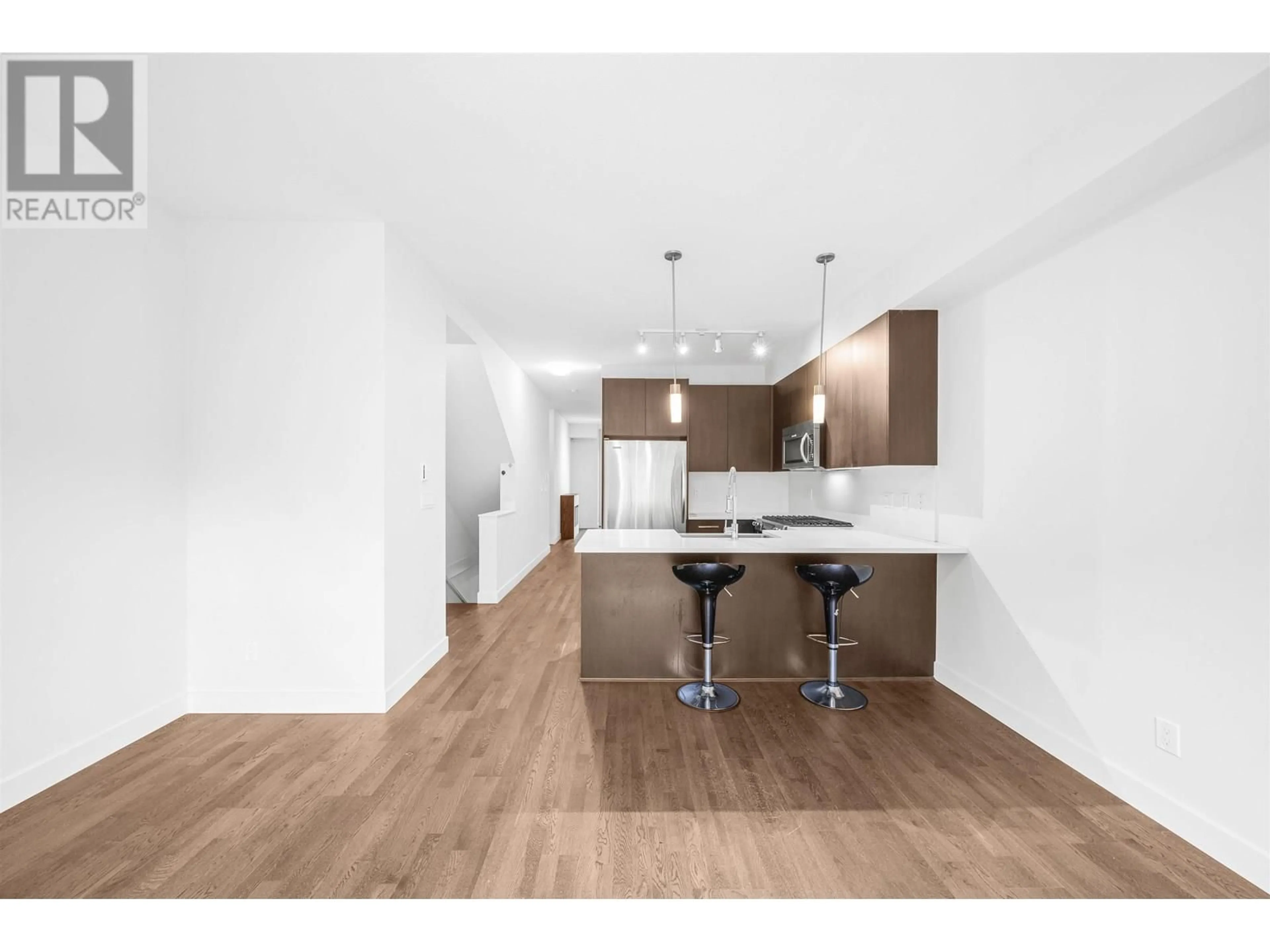 Open concept kitchen, wood/laminate floor for 703 - 8485 NEW HAVEN CLOSE, Burnaby British Columbia V5J0B7