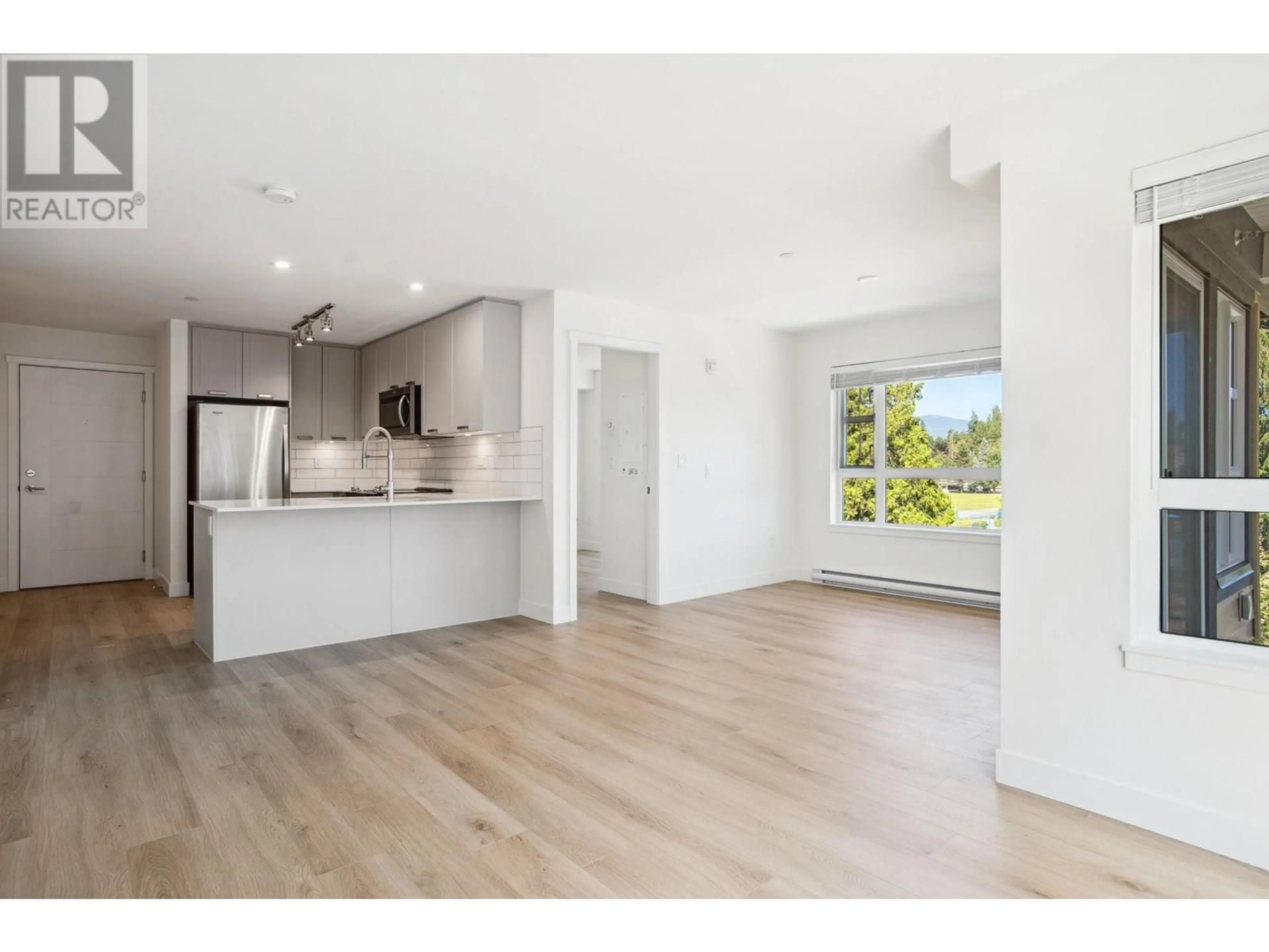 Open concept kitchen, wood/laminate floor for 305 - 22562 121 AVENUE, Maple Ridge British Columbia V2X3Y8