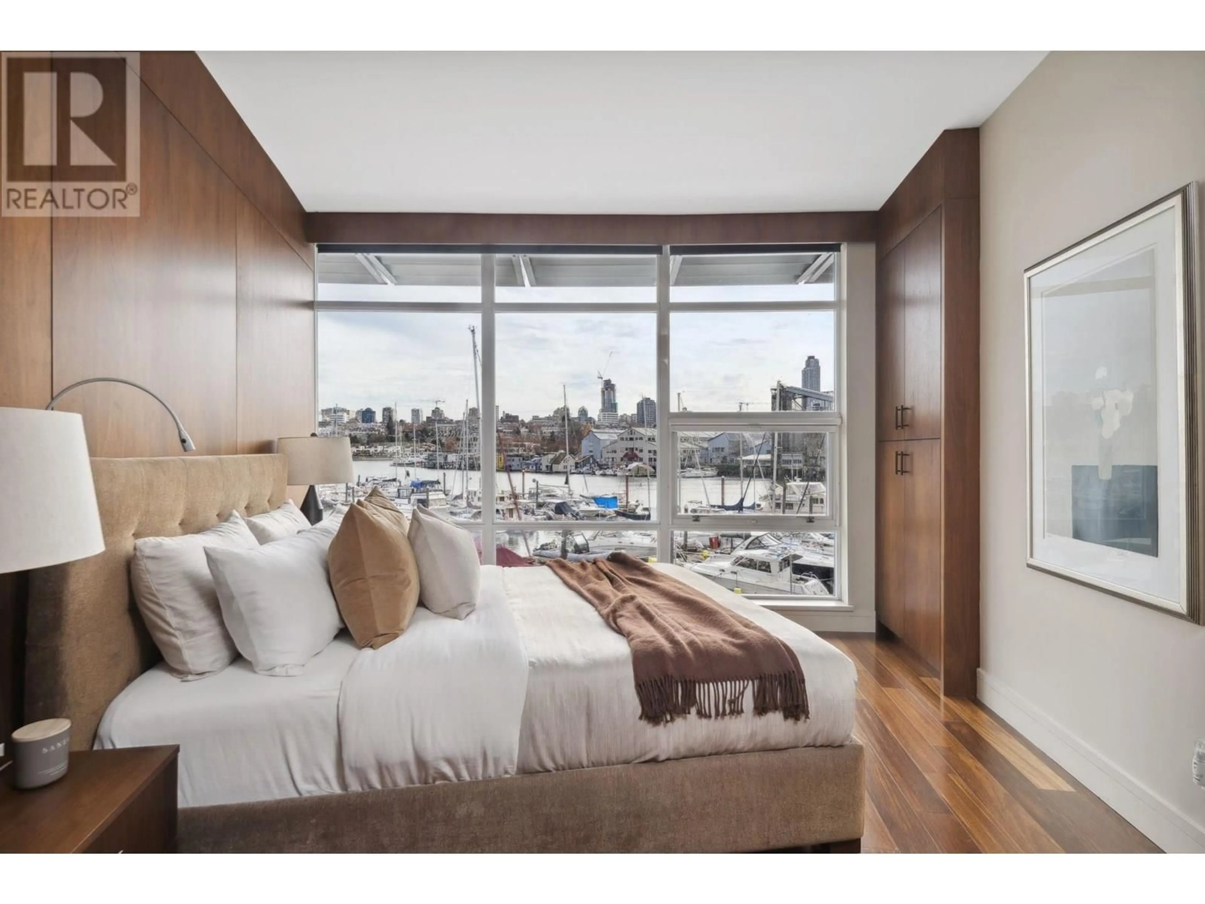 Bedroom with bed, wood/laminate floor for 202 - 628 KINGHORNE MEWS, Vancouver British Columbia V6Z3H6