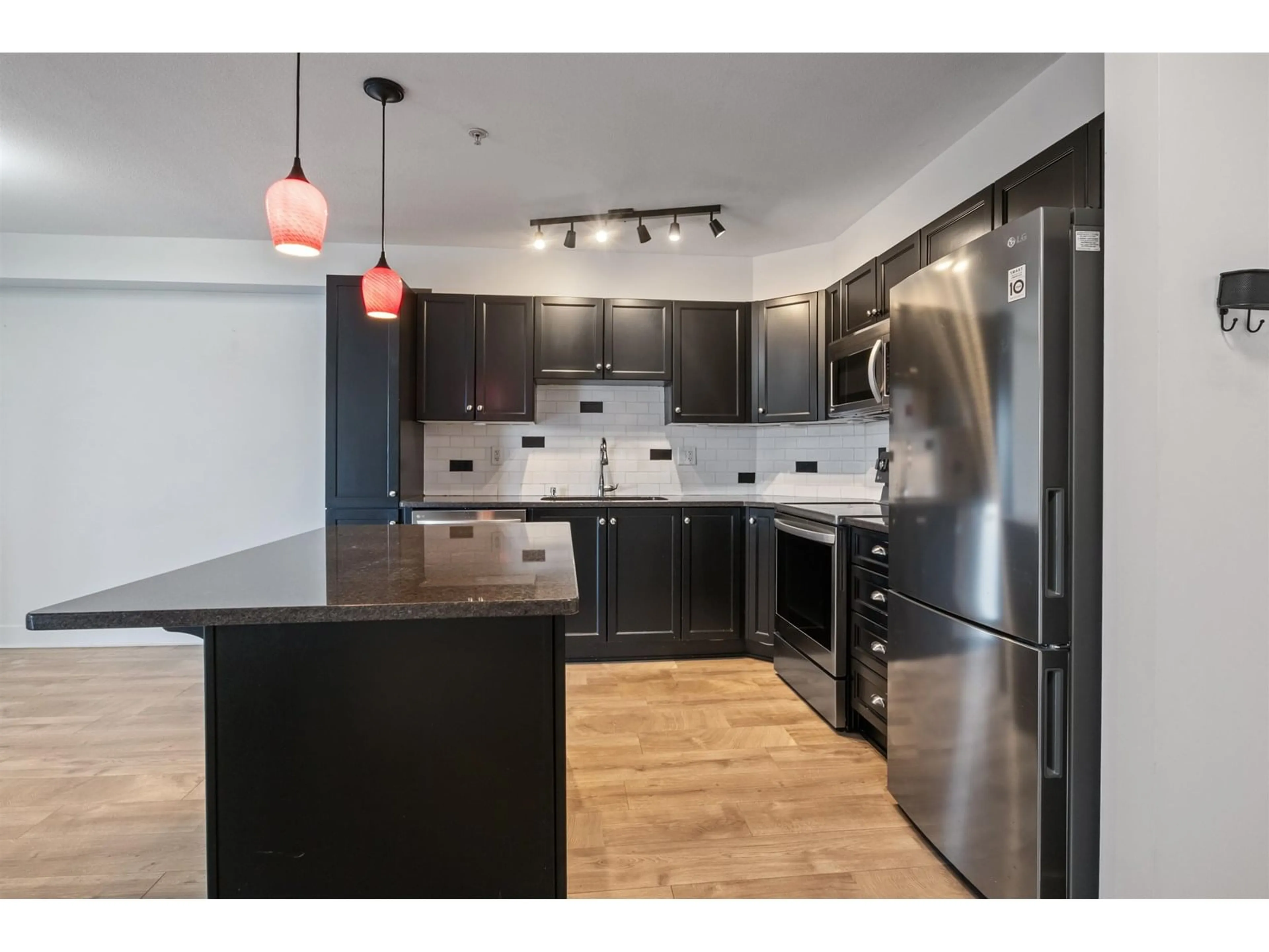 Open concept kitchen, wood/laminate floor for 310 - 30525 CARDINAL, Abbotsford British Columbia V2T0A8