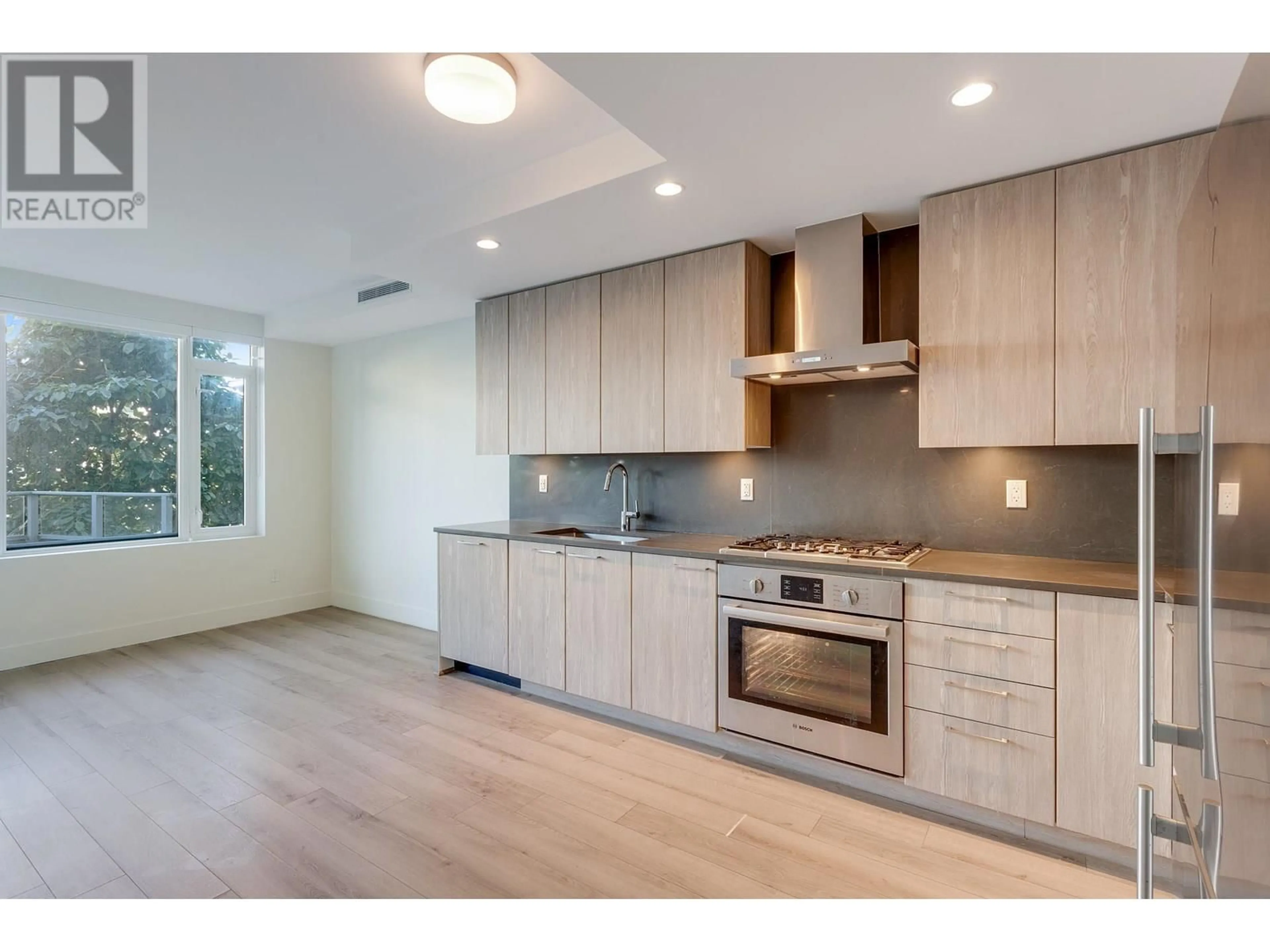 Open concept kitchen, wood/laminate floor for 213 - 10788 NO. 5 ROAD, Richmond British Columbia V6W0B7