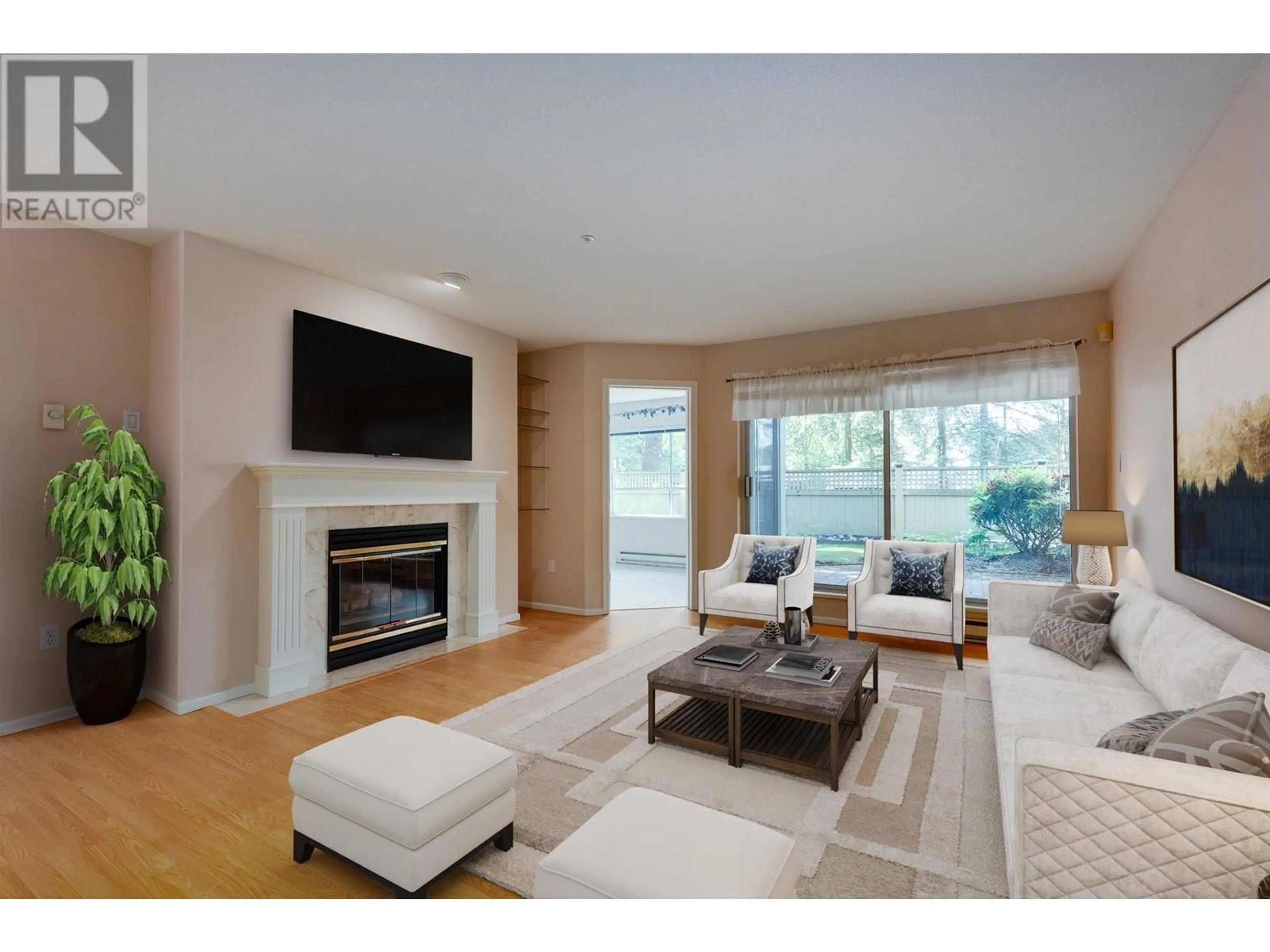 Living room with furniture, wood/laminate floor for 104 - 3690 BANFF COURT, North Vancouver British Columbia V7H2Y7
