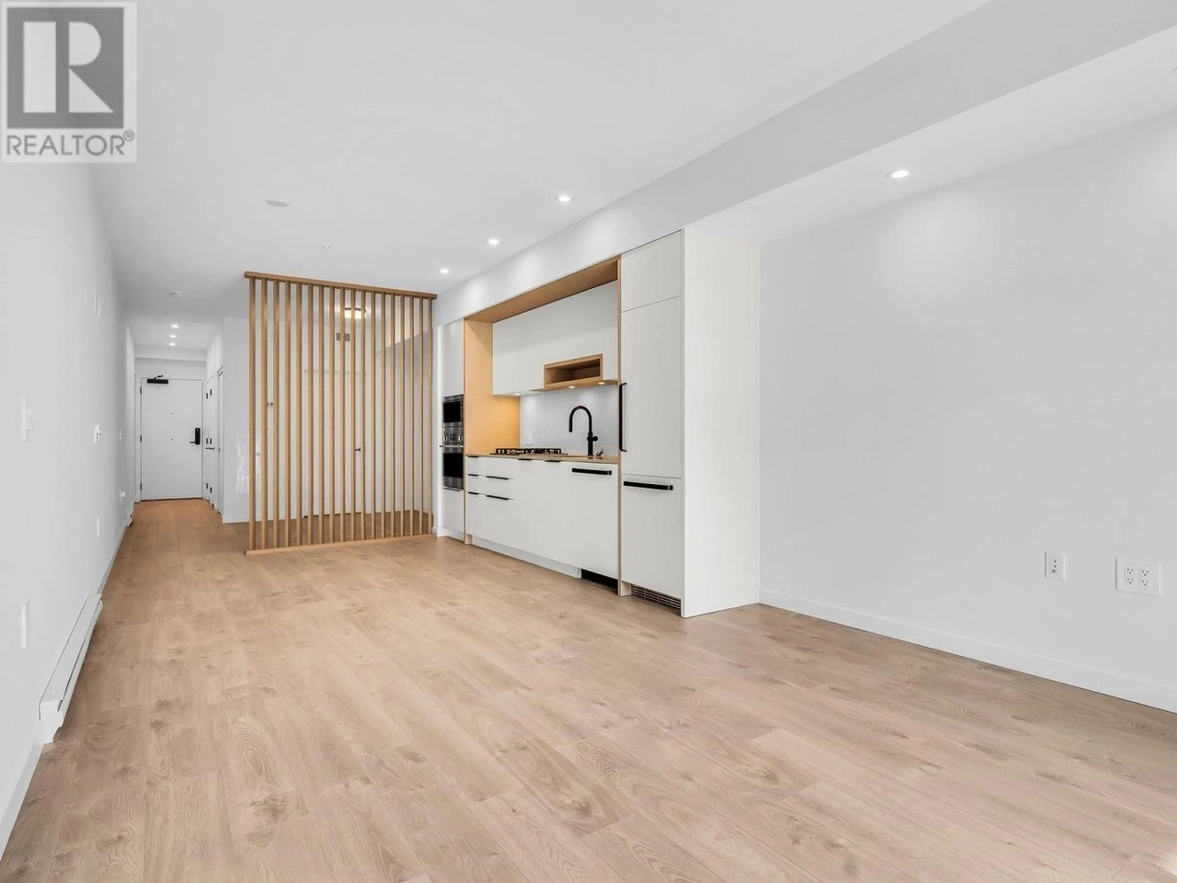 Open concept kitchen, wood/laminate floor for 311 - 2520 GUELPH STREET, Vancouver British Columbia V5T0K7