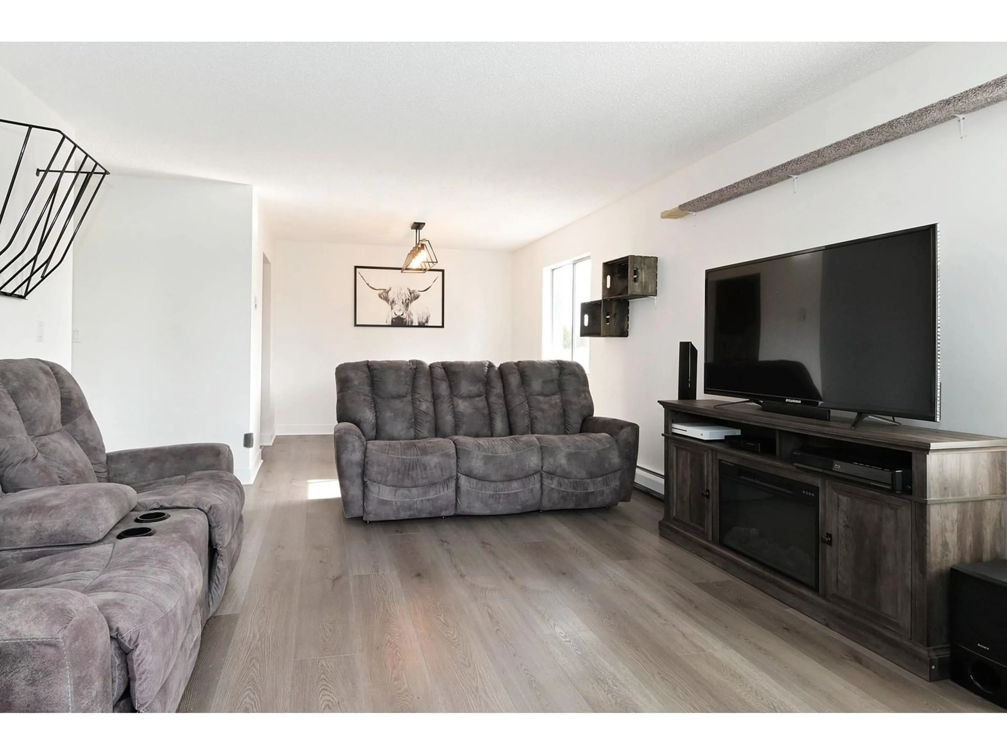 Living room with furniture, wood/laminate floor for 301 - 5700 200, Langley British Columbia V3A7S6