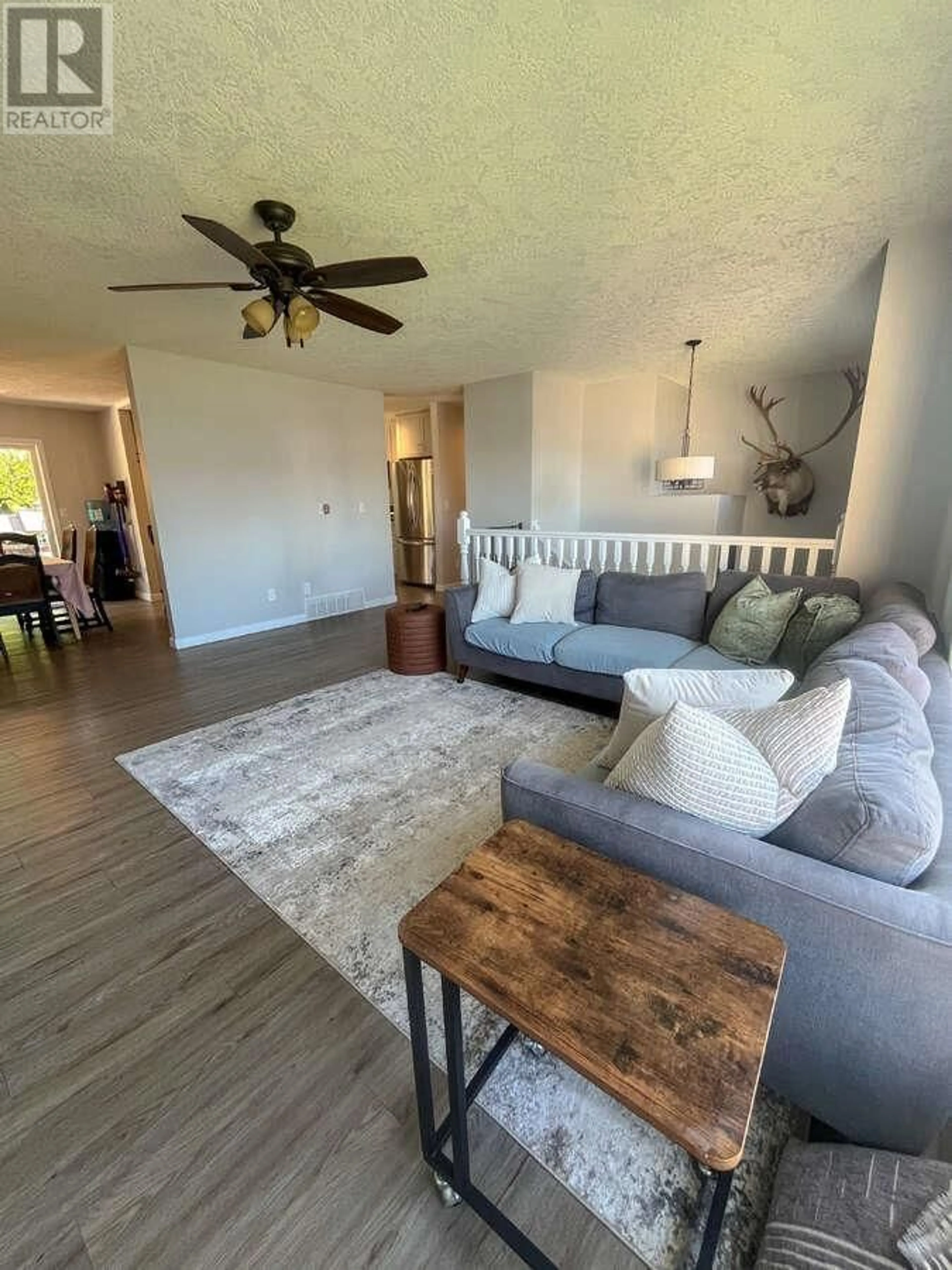 Living room with furniture, wood/laminate floor for 5423 WOODOAK CRESCENT, Prince George British Columbia V2K5A6