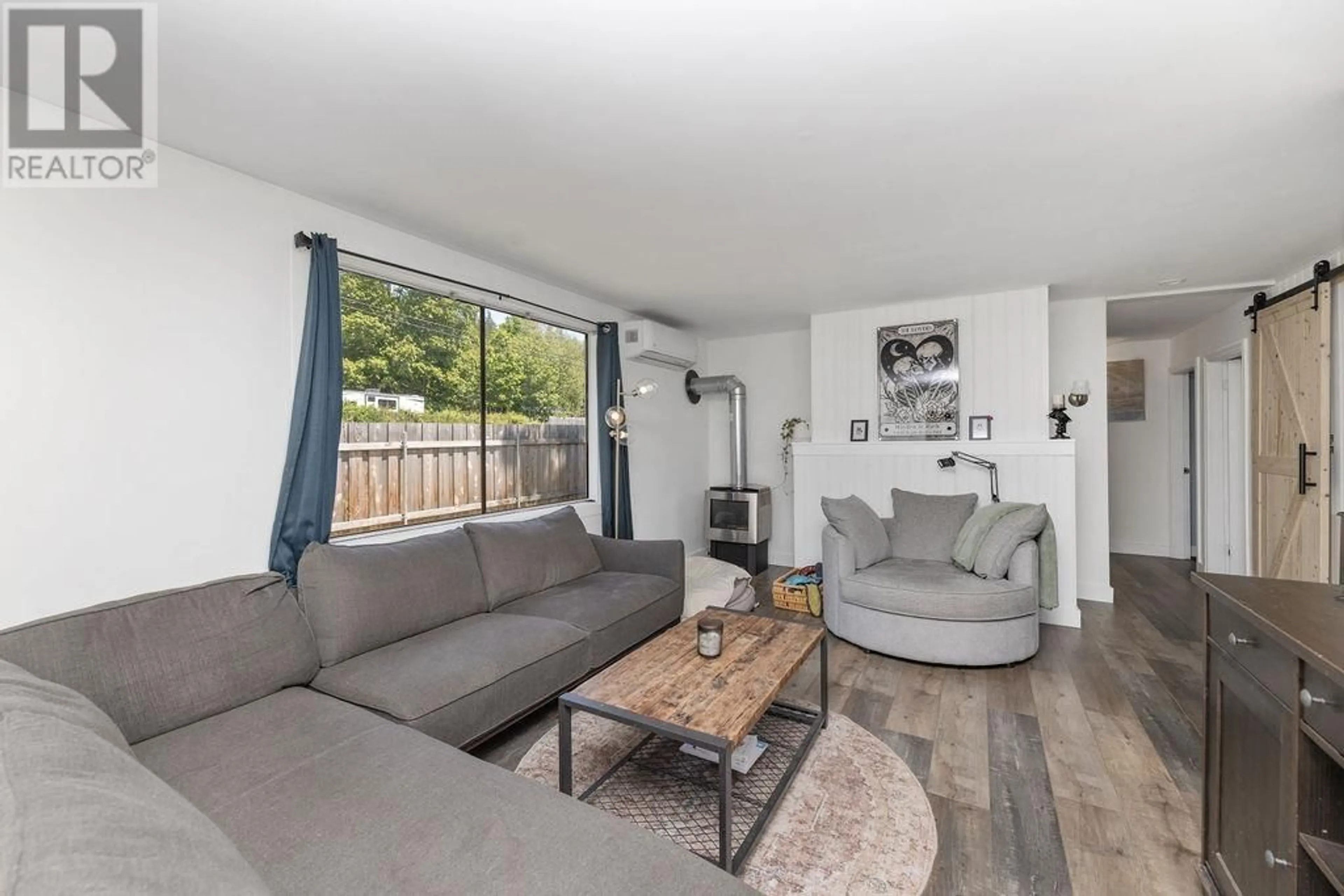 Living room with furniture, wood/laminate floor for 1010 JOE ROAD, Roberts Creek British Columbia V0N2W6