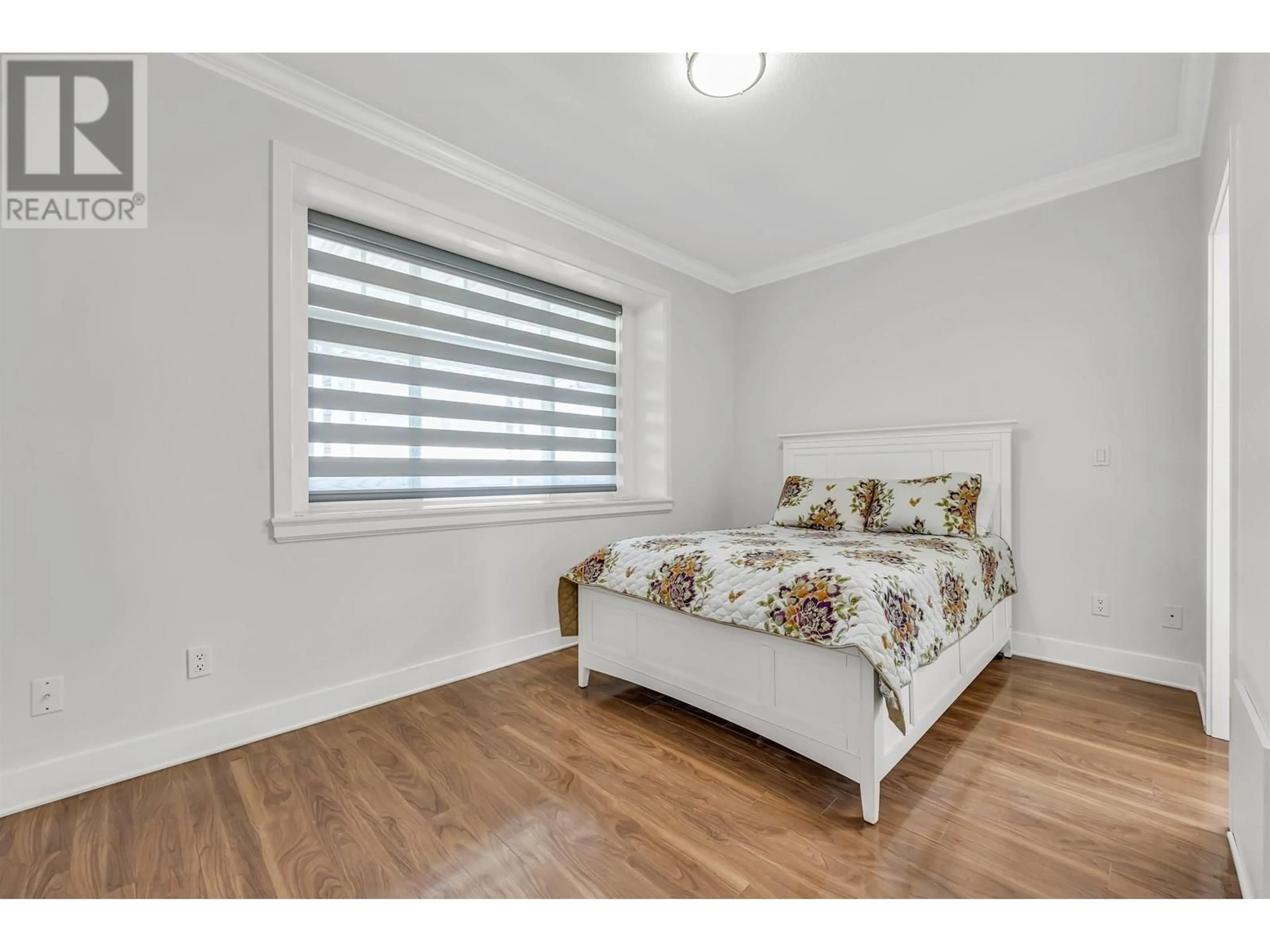 Bedroom with bed, wood/laminate floor for 5688 SHERBROOKE STREET, Vancouver British Columbia V5W1R3