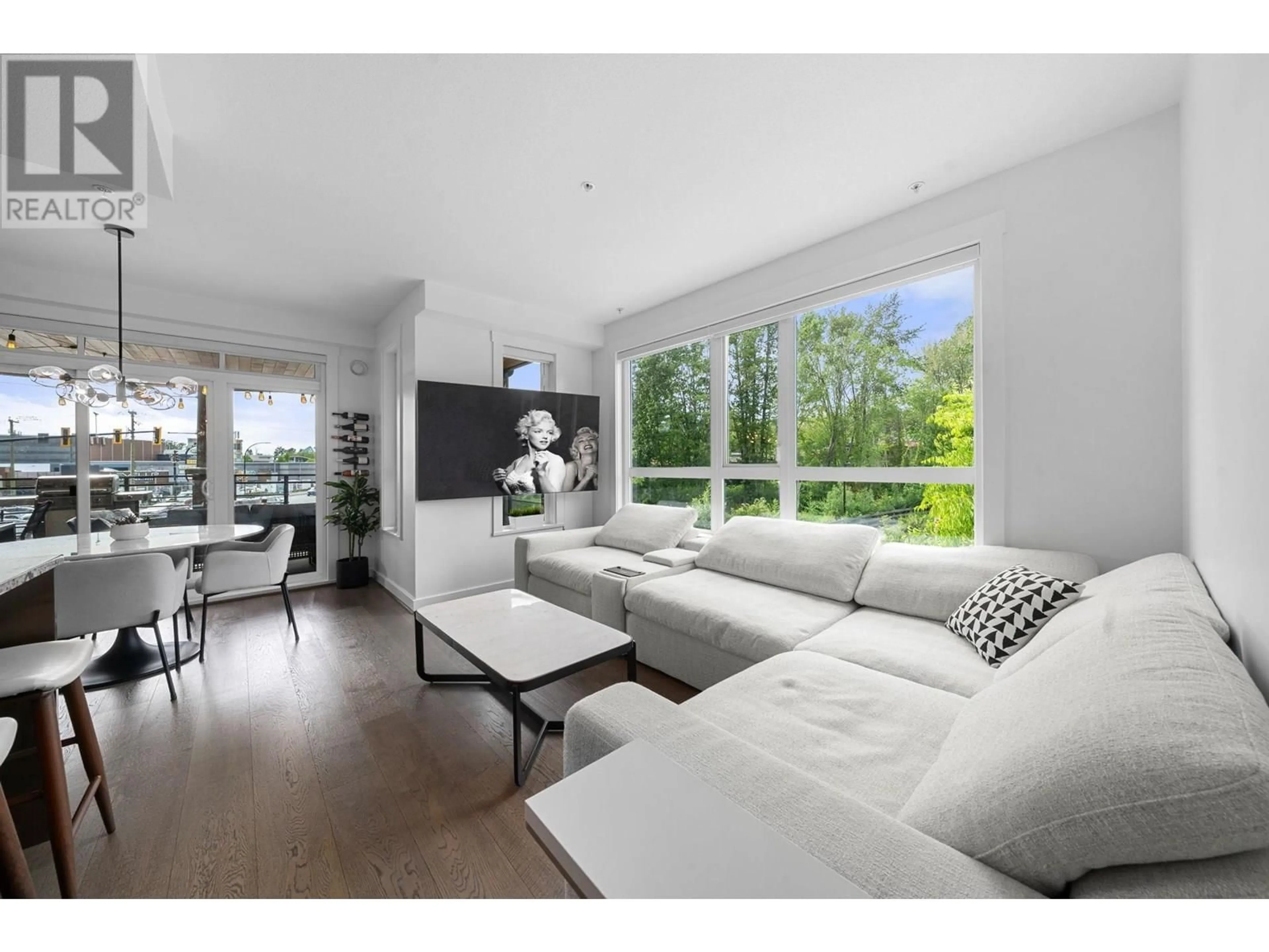 Living room with furniture, wood/laminate floor for 218 - 733 14TH STREET, North Vancouver British Columbia V7M0C6