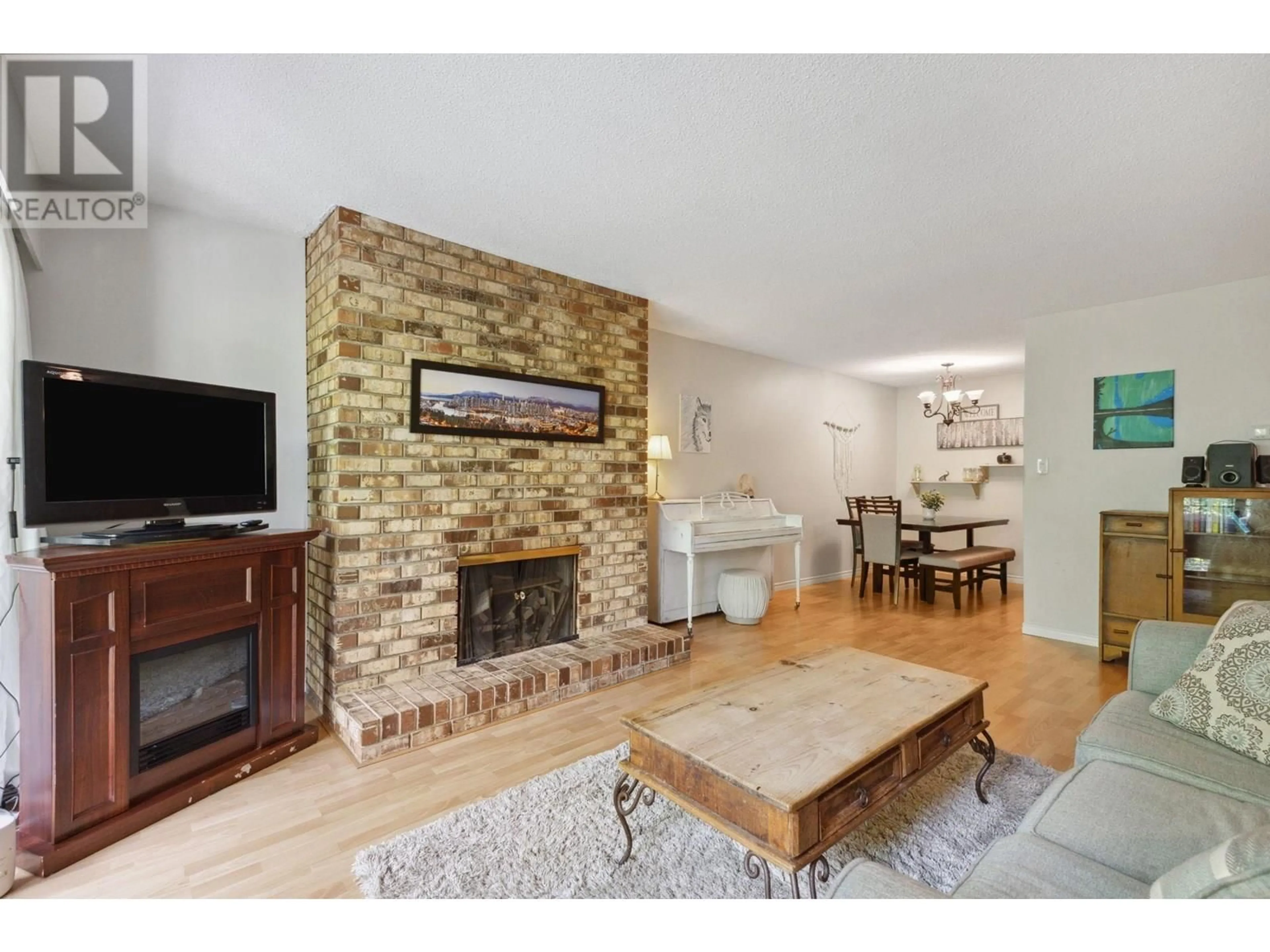 Living room with furniture, wood/laminate floor for 306 - 1385 DRAYCOTT ROAD, North Vancouver British Columbia V7J3K9