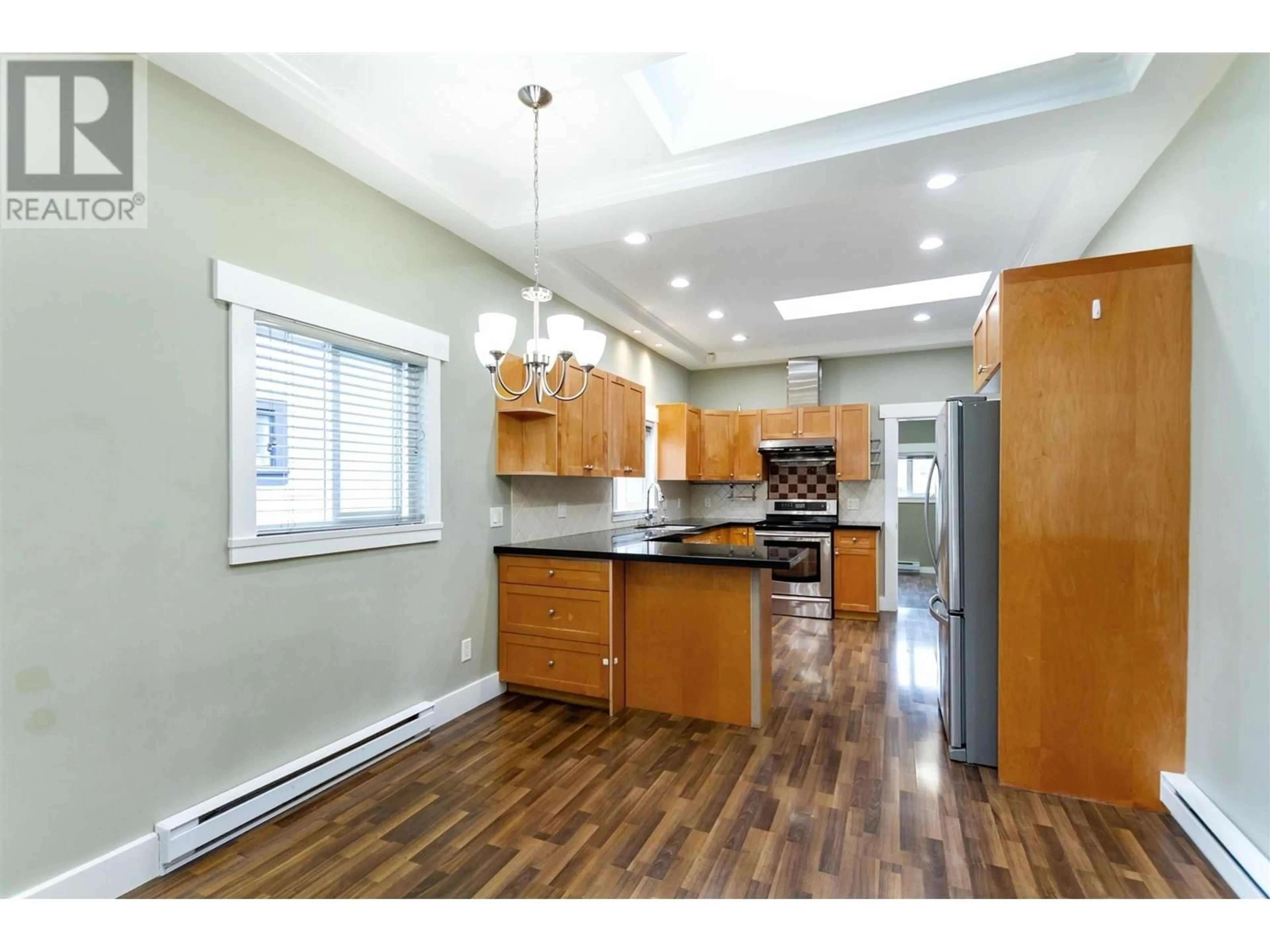 Open concept kitchen, wood/laminate floor for 3423 27TH AVENUE, Vancouver British Columbia V5R1P8
