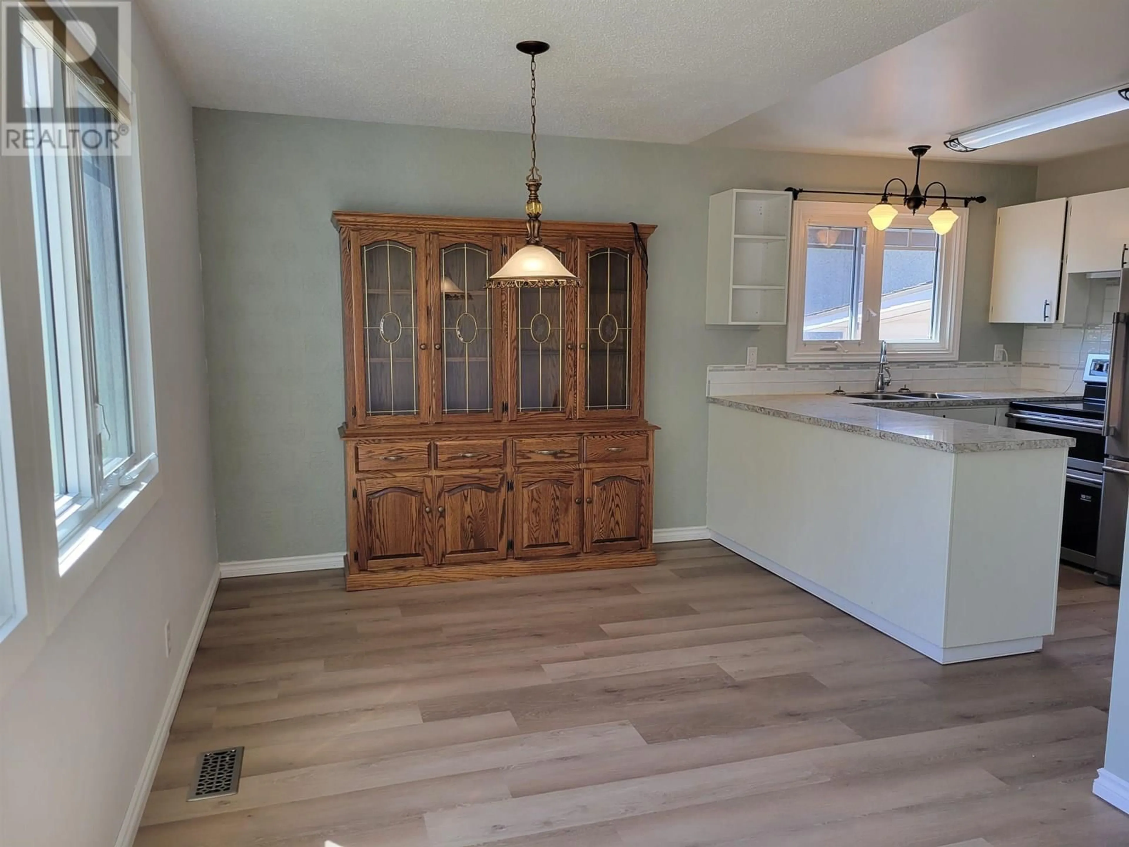 Open concept kitchen, wood/laminate floor for 177 5TH STREET, Vanderhoof British Columbia V0J3A0