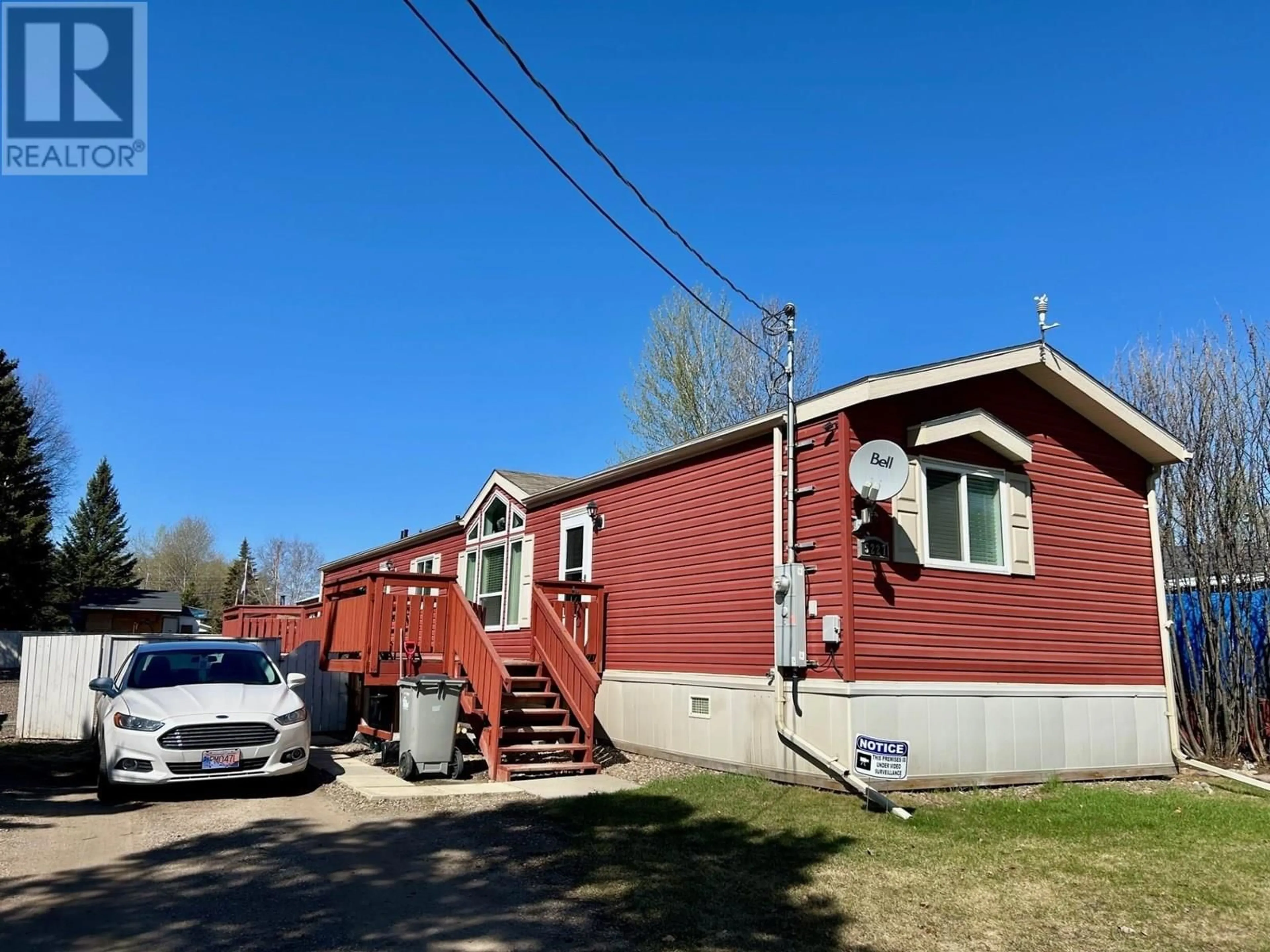 Home with vinyl exterior material, street for 5227 42 STREET, Fort Nelson British Columbia V0C1R0