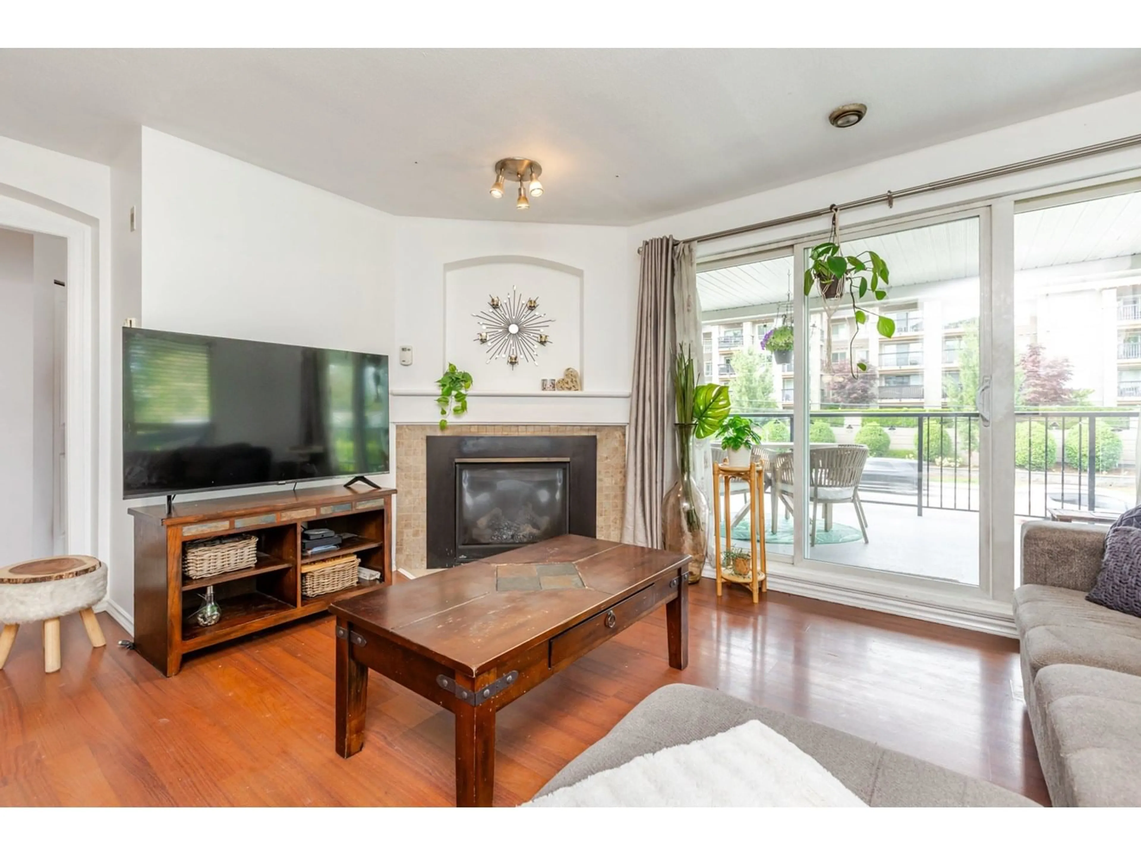 Living room with furniture, wood/laminate floor for 103 - 20976 56, Langley British Columbia V3A7Z2