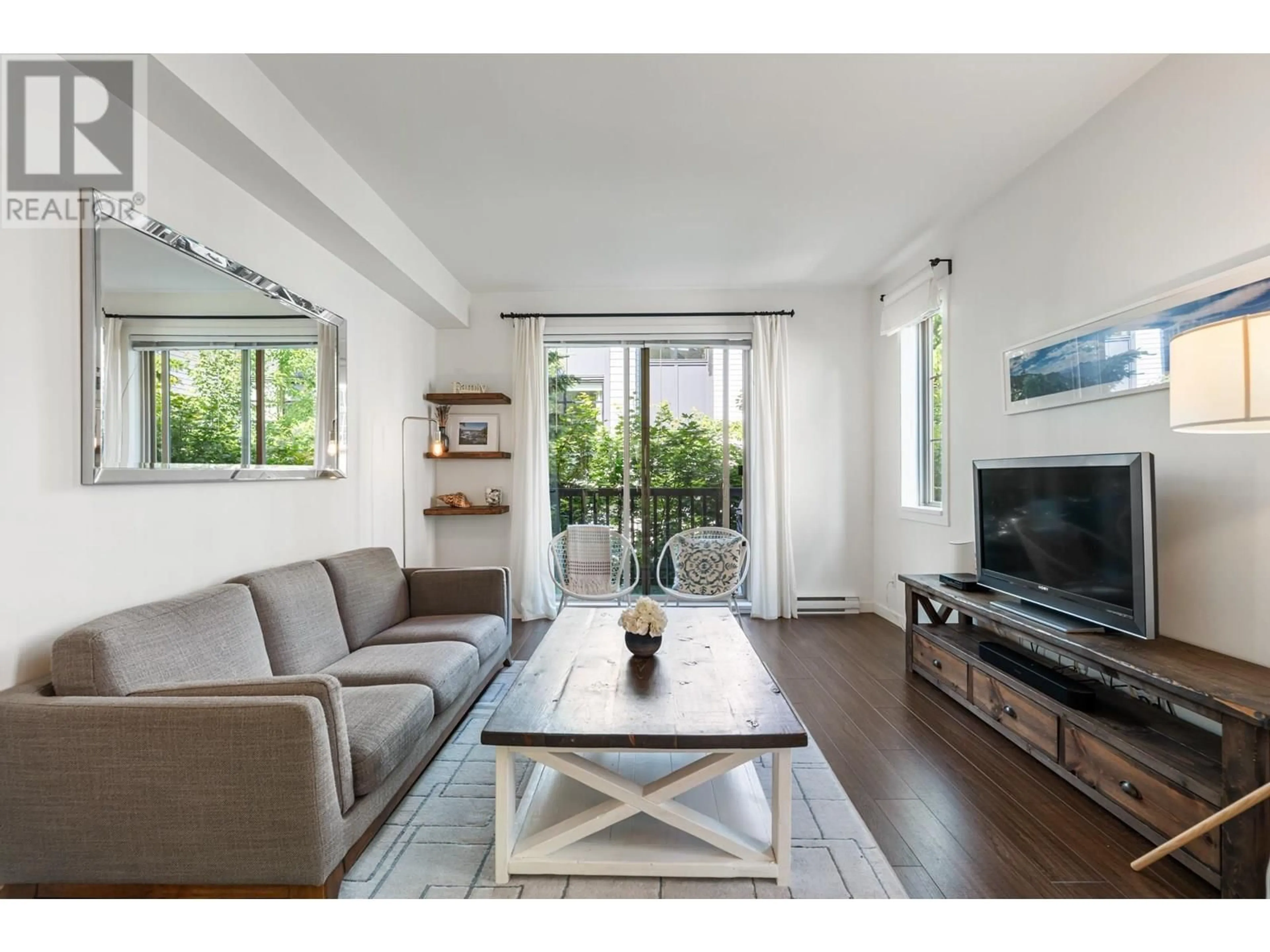 Living room with furniture, wood/laminate floor for 45 - 433 SEYMOUR RIVER PLACE, North Vancouver British Columbia V7H0B8