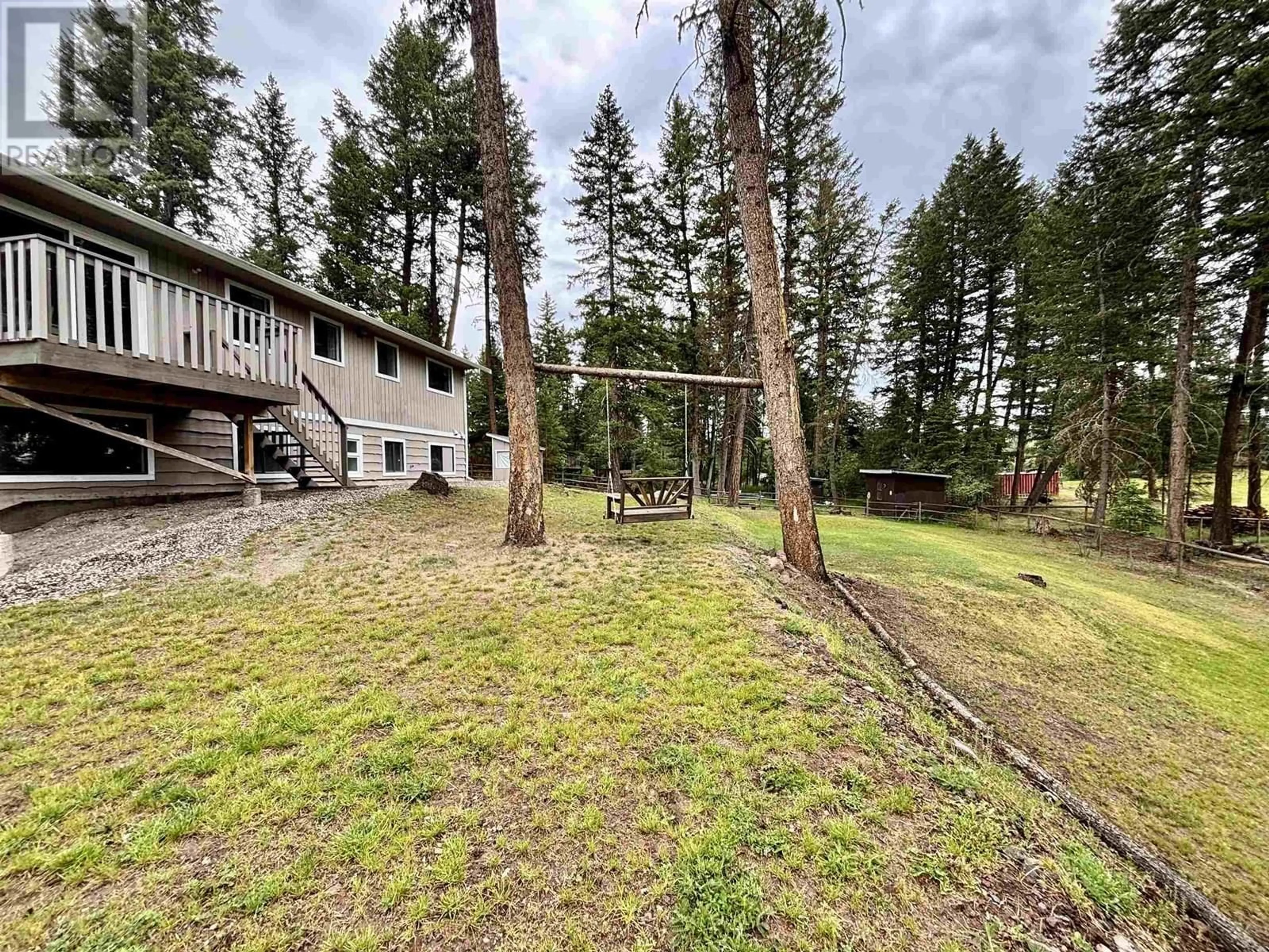 A pic from outside/outdoor area/front of a property/back of a property/a pic from drone, forest/trees view for 5336 ANNAHAM CRESCENT, 108 Mile Ranch British Columbia V0K2Z0