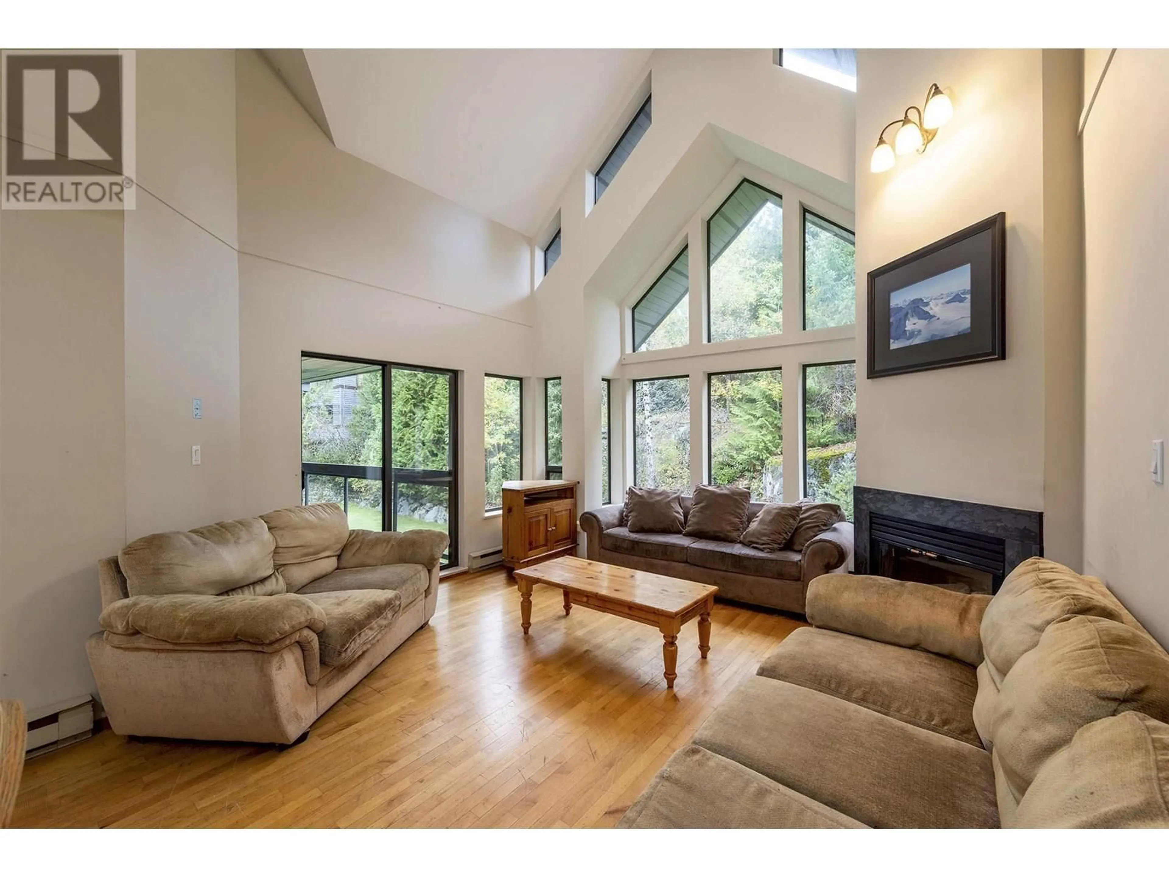 Living room with furniture, wood/laminate floor for 306 - 3212 BLUEBERRY DRIVE, Whistler British Columbia V8E0T5