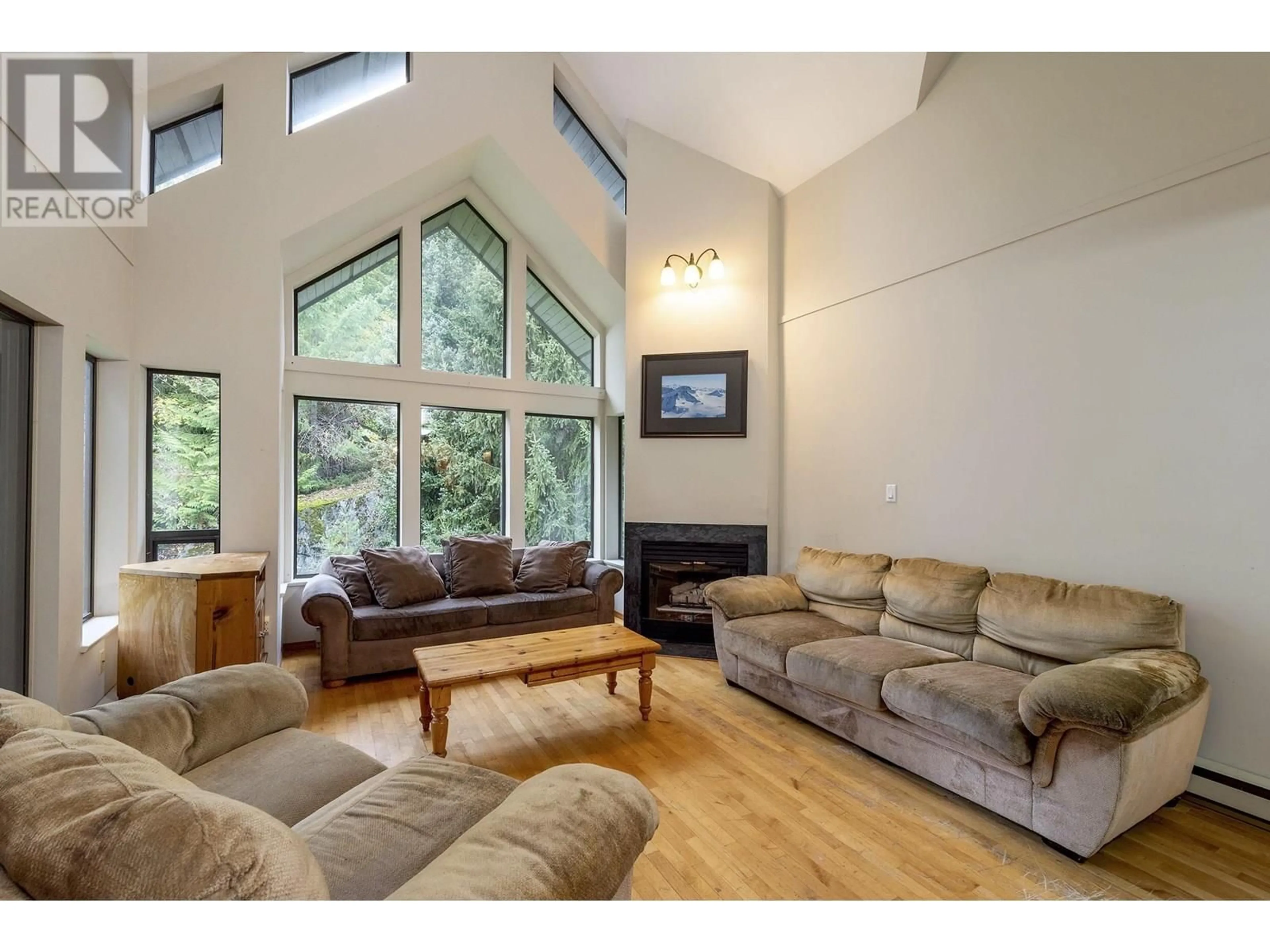 Living room with furniture, wood/laminate floor for 306 - 3212 BLUEBERRY DRIVE, Whistler British Columbia V8E0T5