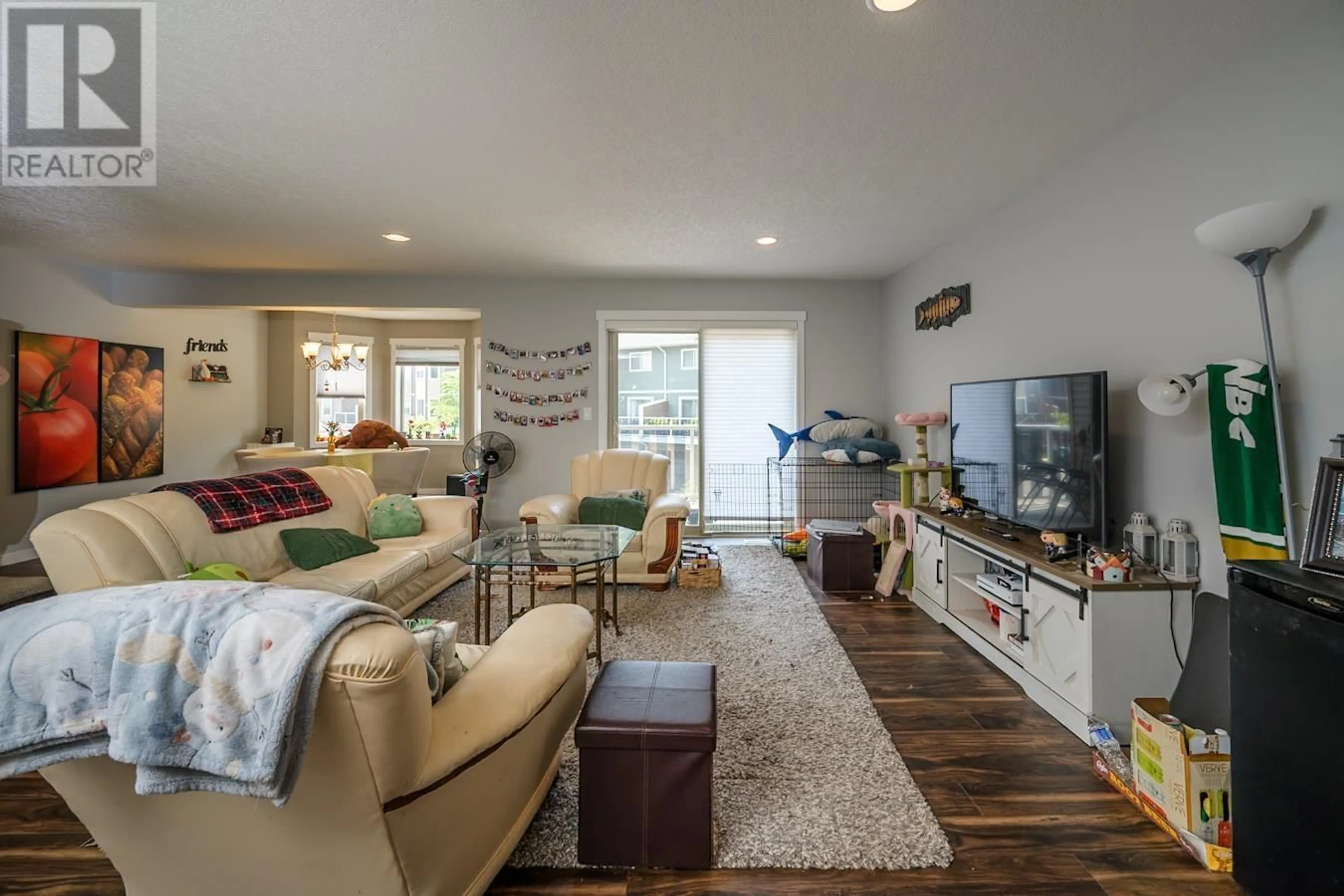 Living room with furniture, wood/laminate floor for 302 - 7400 CREEKSIDE WAY, Prince George British Columbia V2N0G6