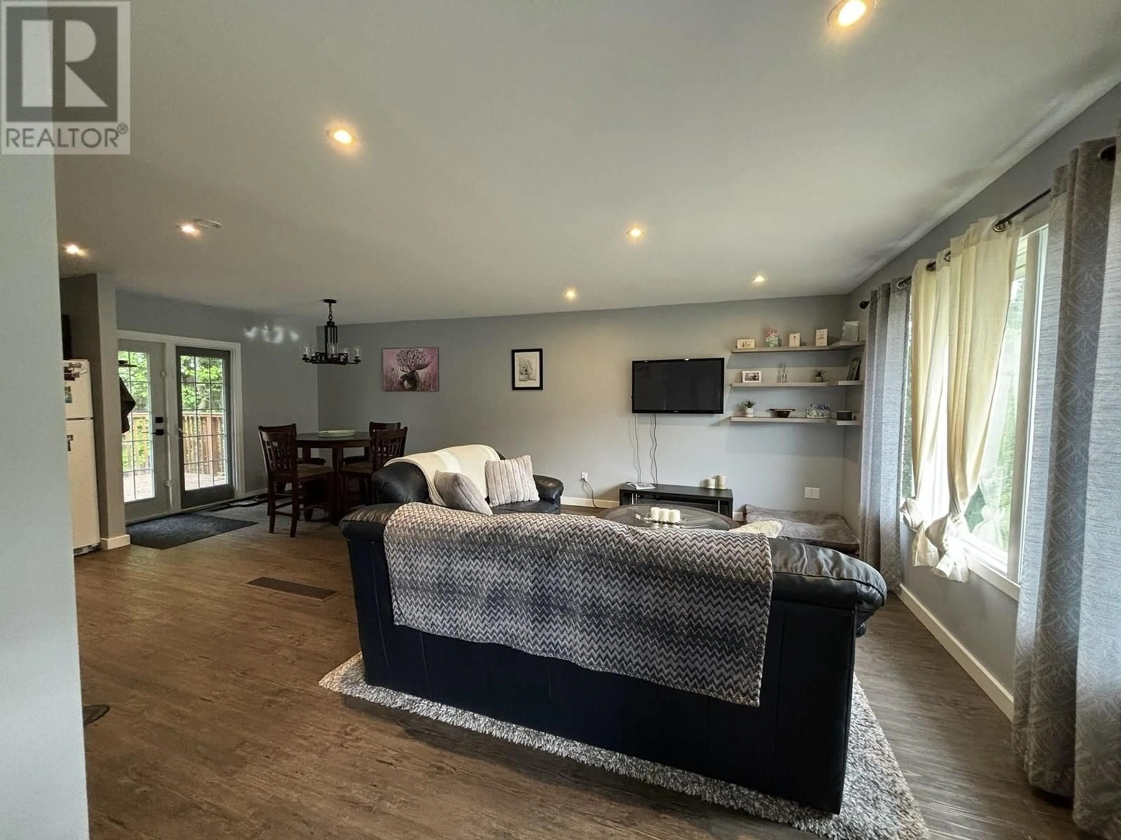 Living room with furniture, wood/laminate floor for 6880 LILAC CRESCENT, Prince George British Columbia V2K3G8