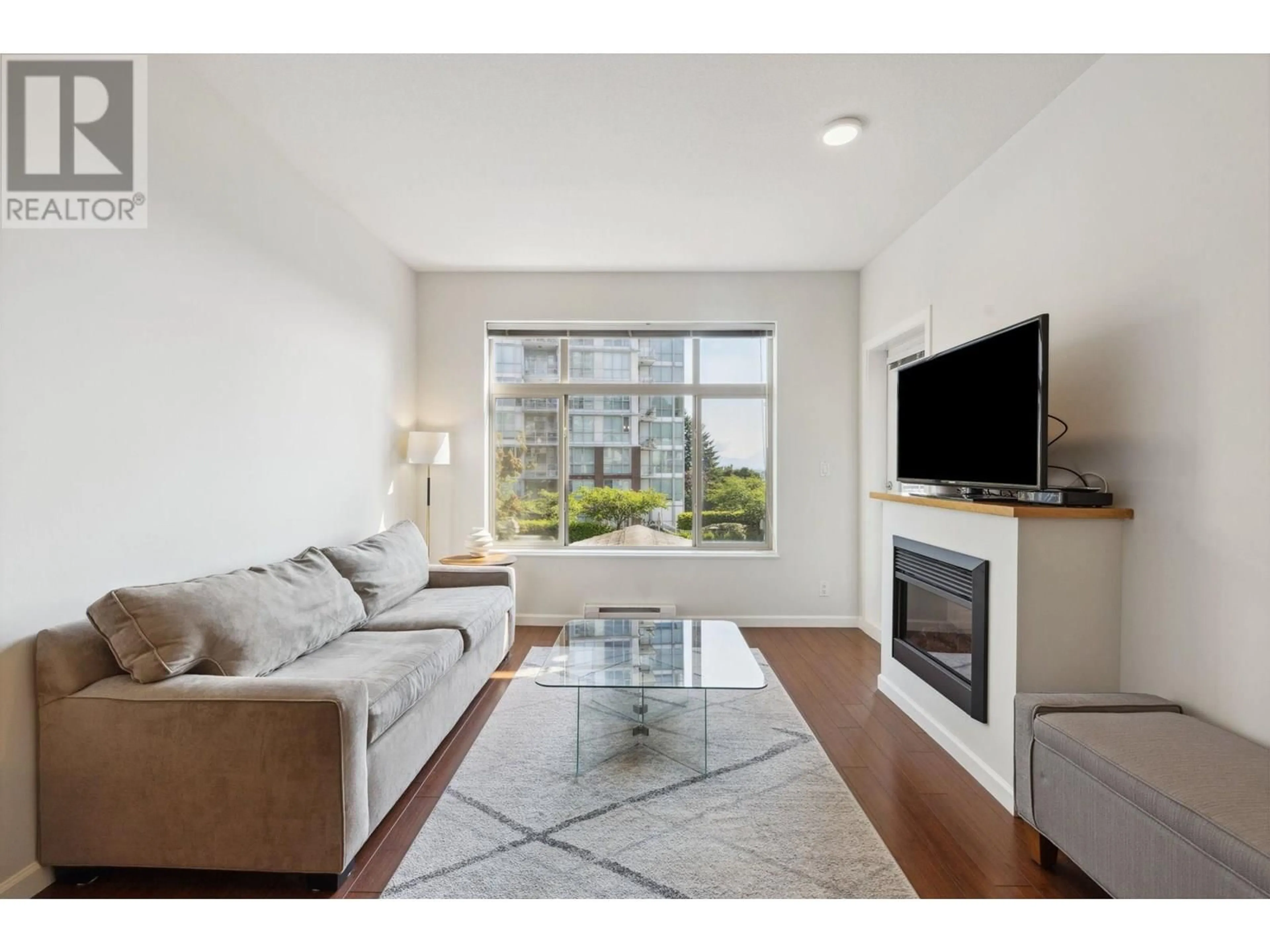 Living room with furniture, wood/laminate floor for 310 - 290 FRANCIS WAY, New Westminster British Columbia V3L0C4