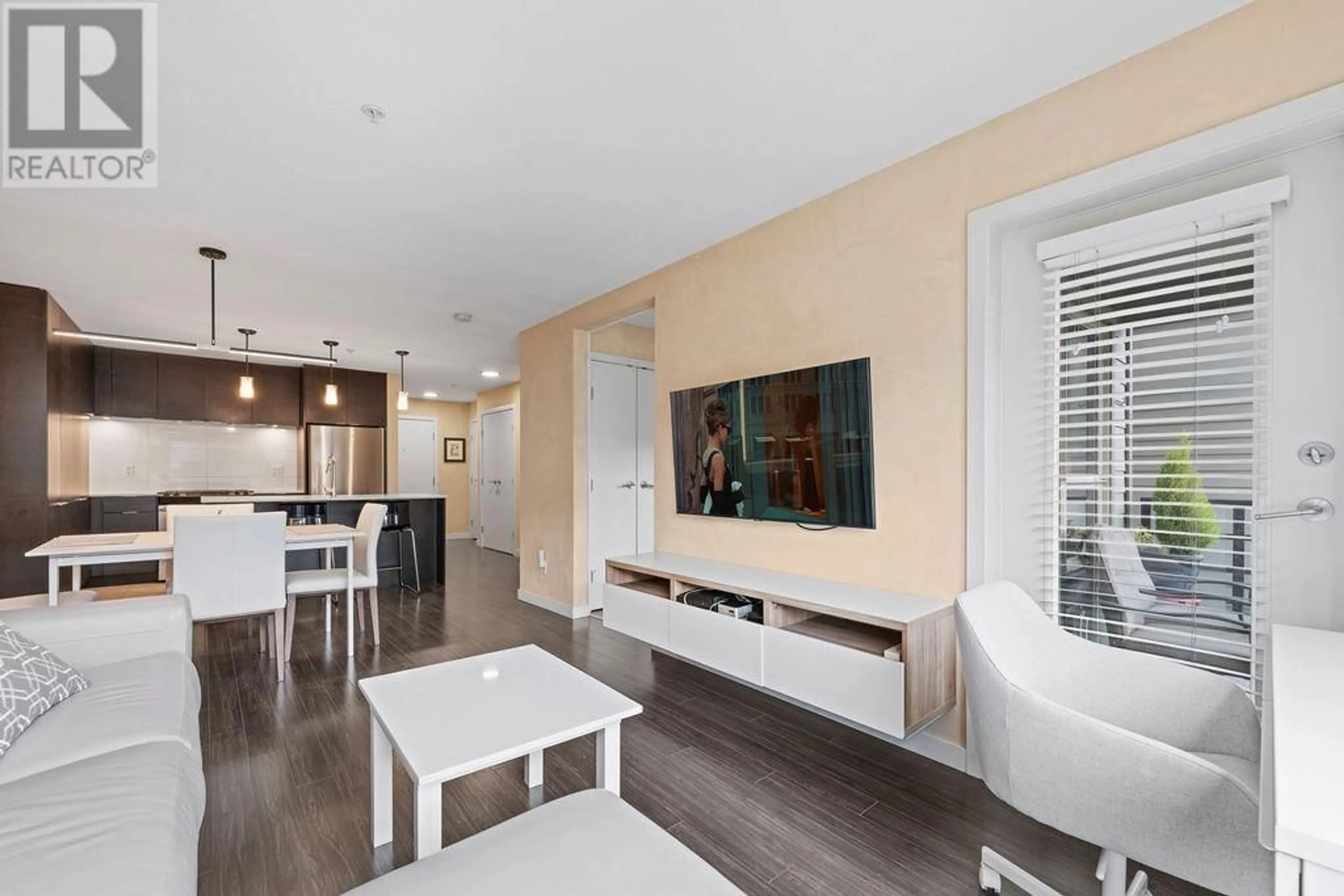 Living room with furniture, wood/laminate floor for 312 - 1679 LLOYD AVENUE, Vancouver British Columbia V7P0A9