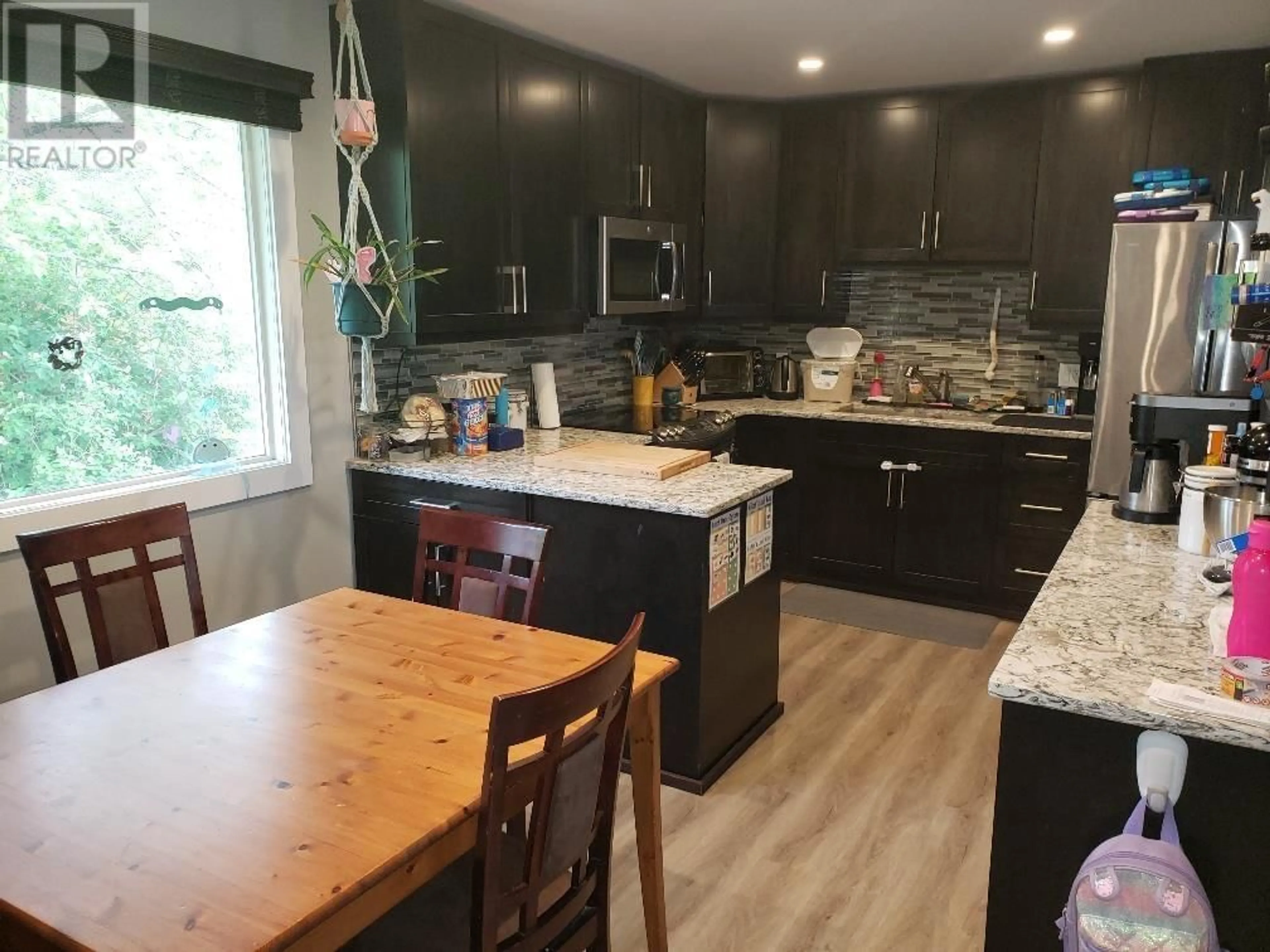 Open concept kitchen, wood/laminate floor for 4626 MUNTHE AVENUE, Terrace British Columbia V8G2H8