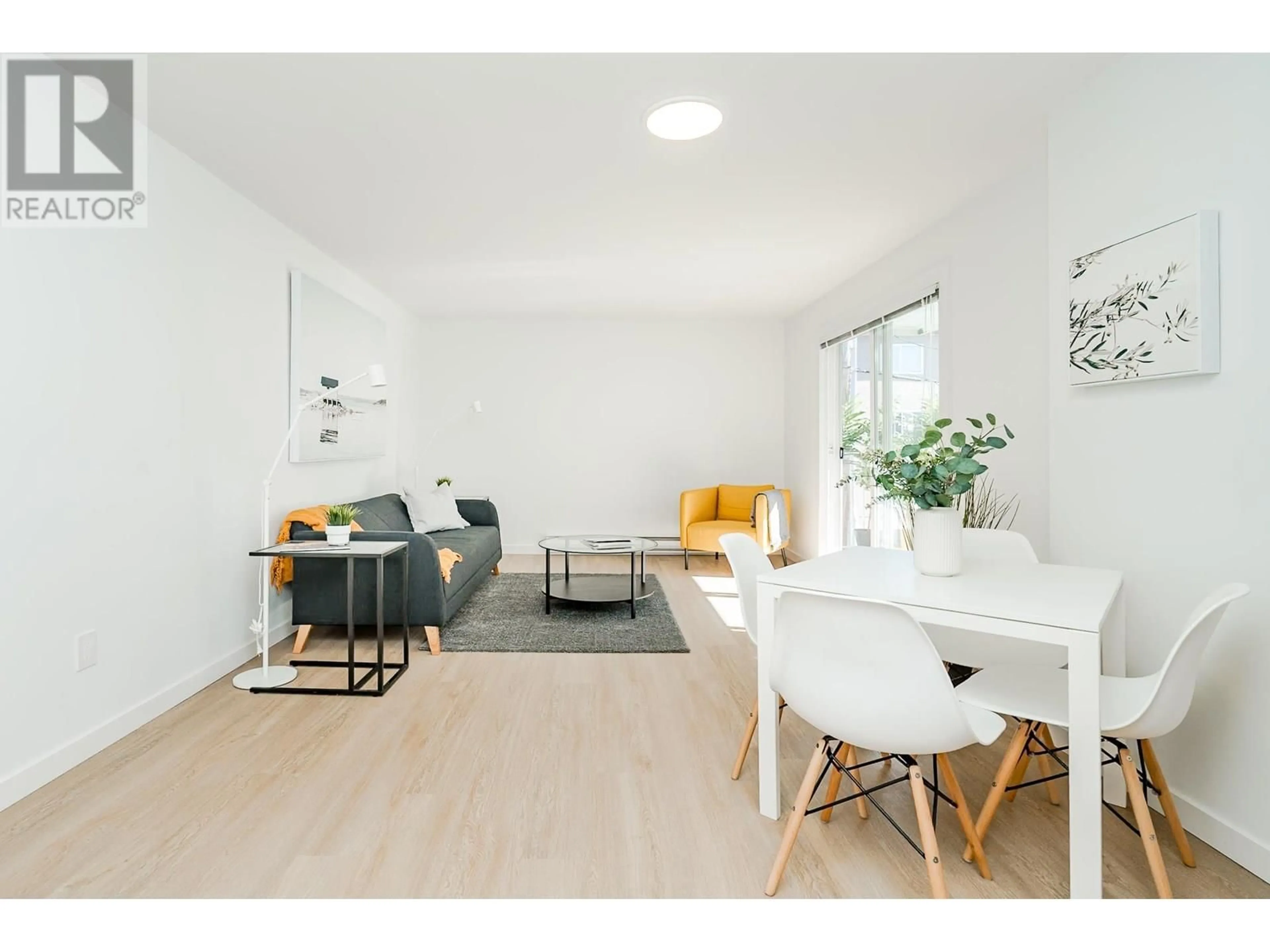 Living room with furniture, wood/laminate floor for 202 - 8690 MONTCALM STREET, Vancouver British Columbia V6P4P8
