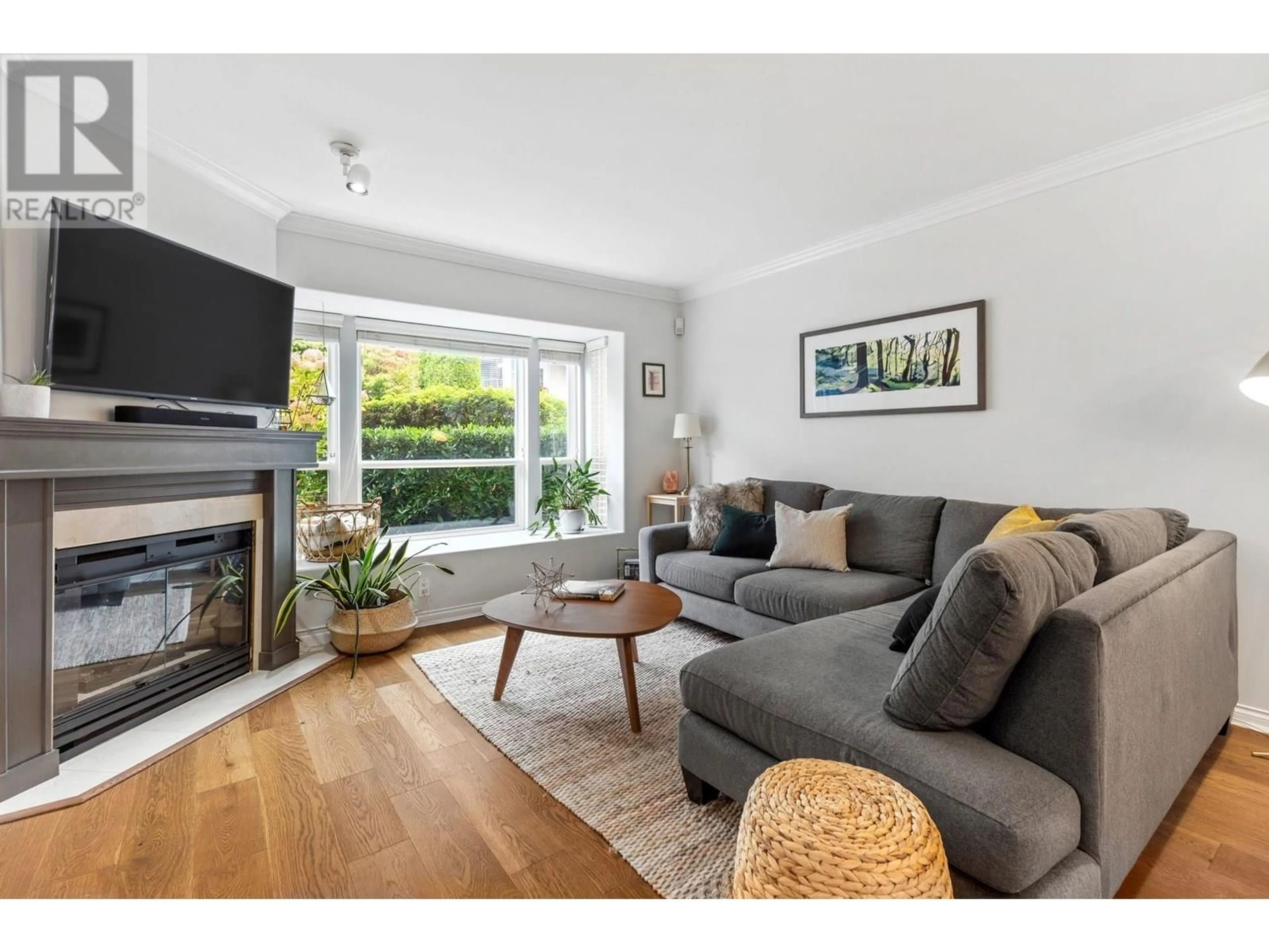 Living room with furniture, wood/laminate floor for 112 - 225 6TH STREET, North Vancouver British Columbia V7L1P4