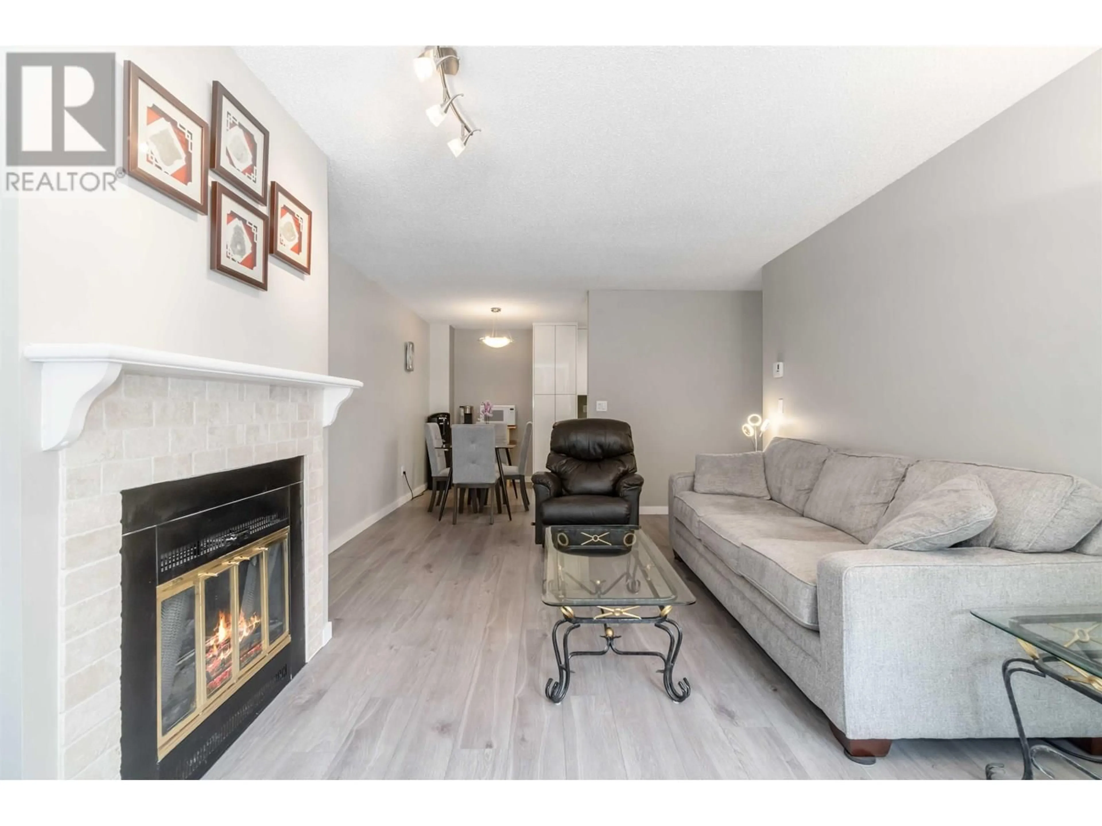 Living room with furniture, wood/laminate floor for 104 - 7571 MOFFATT ROAD, Richmond British Columbia V6Y3N1