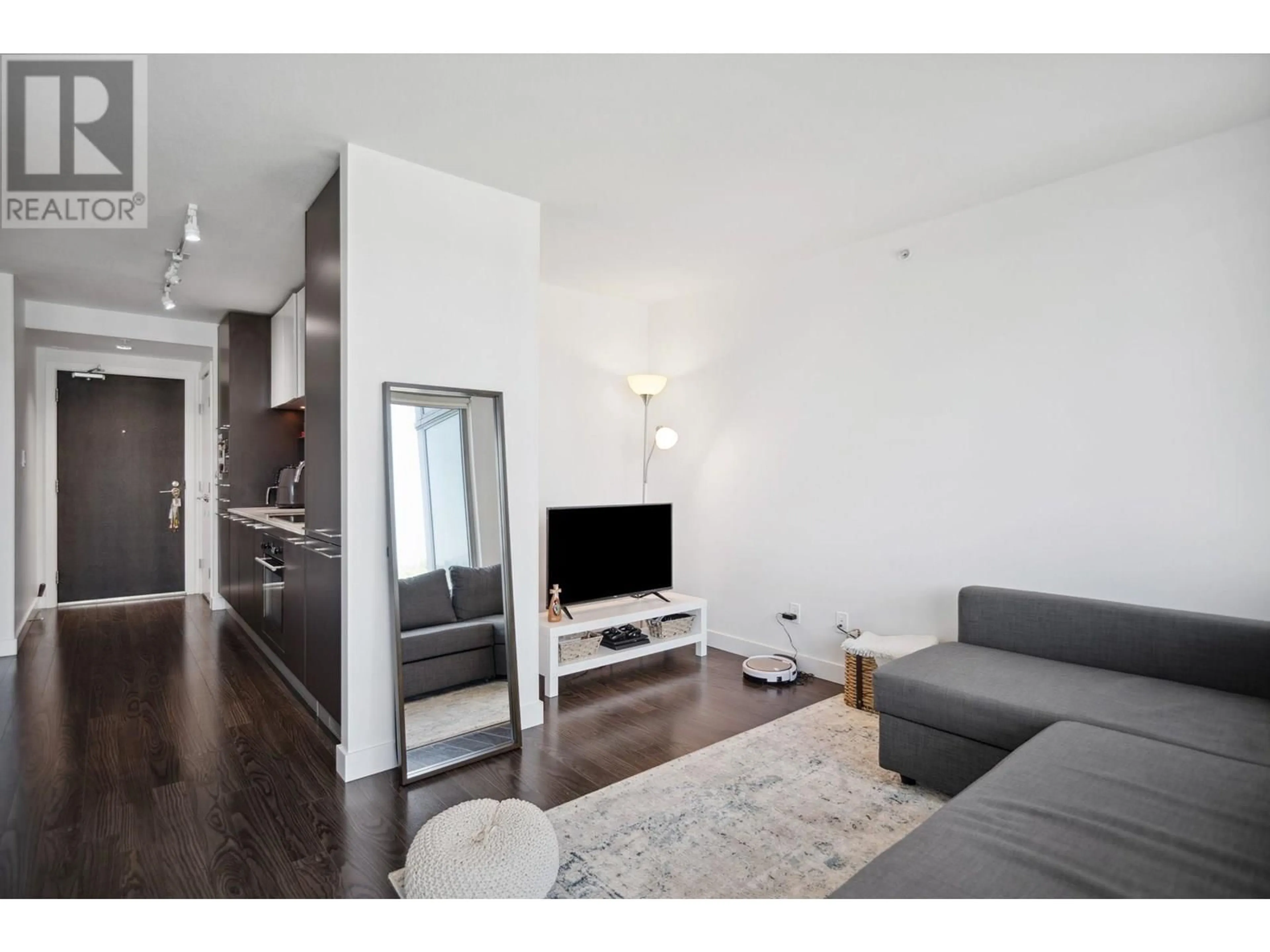Living room with furniture, wood/laminate floor for 1003 - 8131 NUNAVUT LANE, Vancouver British Columbia V5X0E2