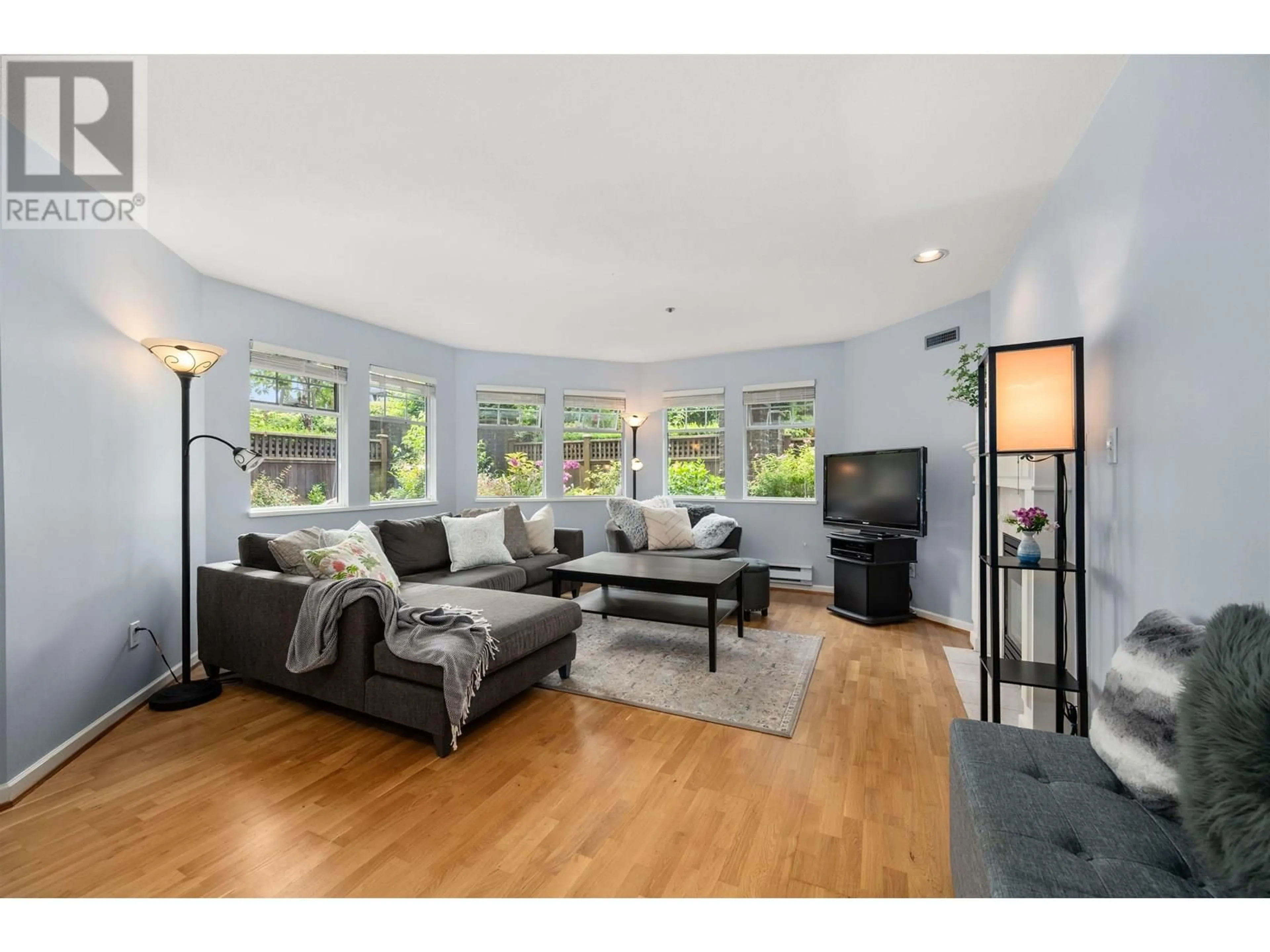 Living room with furniture, wood/laminate floor for 101 - 1989 1ST AVENUE, Vancouver British Columbia V6J1G7