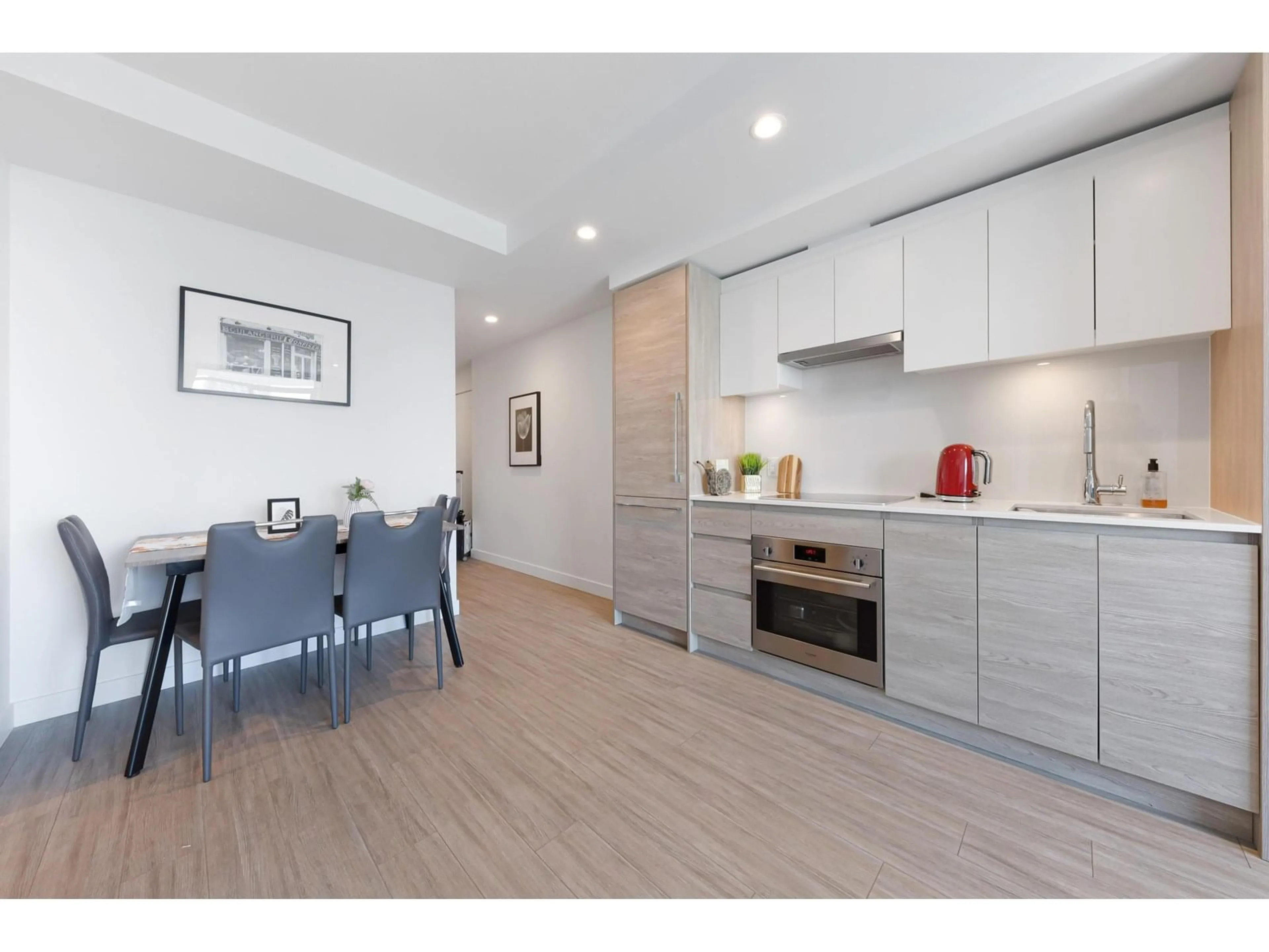 Open concept kitchen, wood/laminate floor for 2112 - 13615 FRASER, Surrey British Columbia V3T0P7