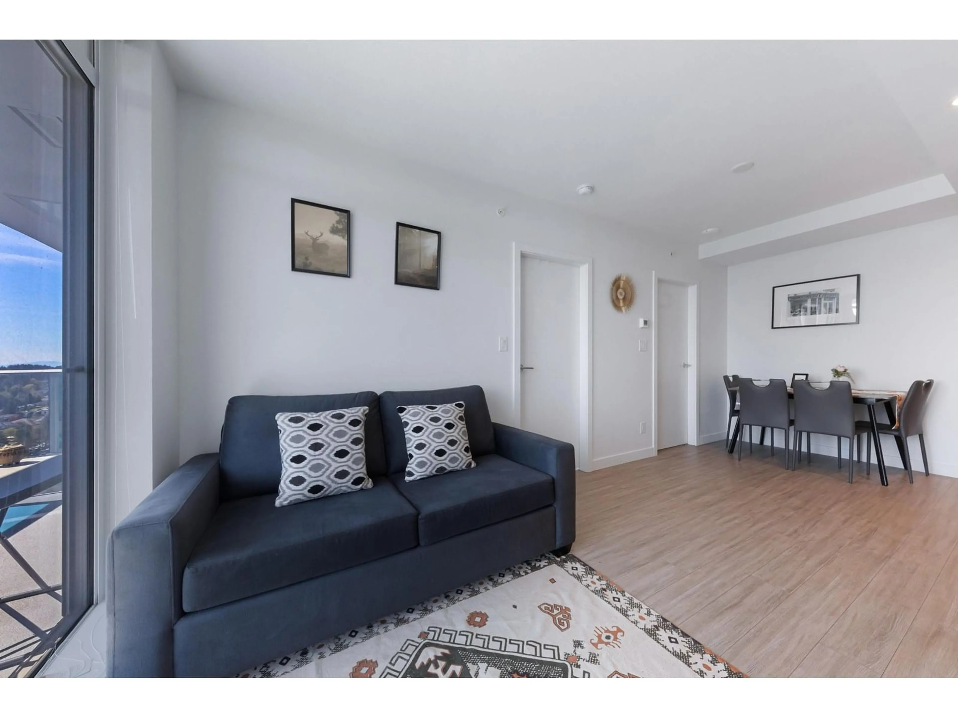 Living room with furniture, wood/laminate floor for 2112 - 13615 FRASER, Surrey British Columbia V3T0P7