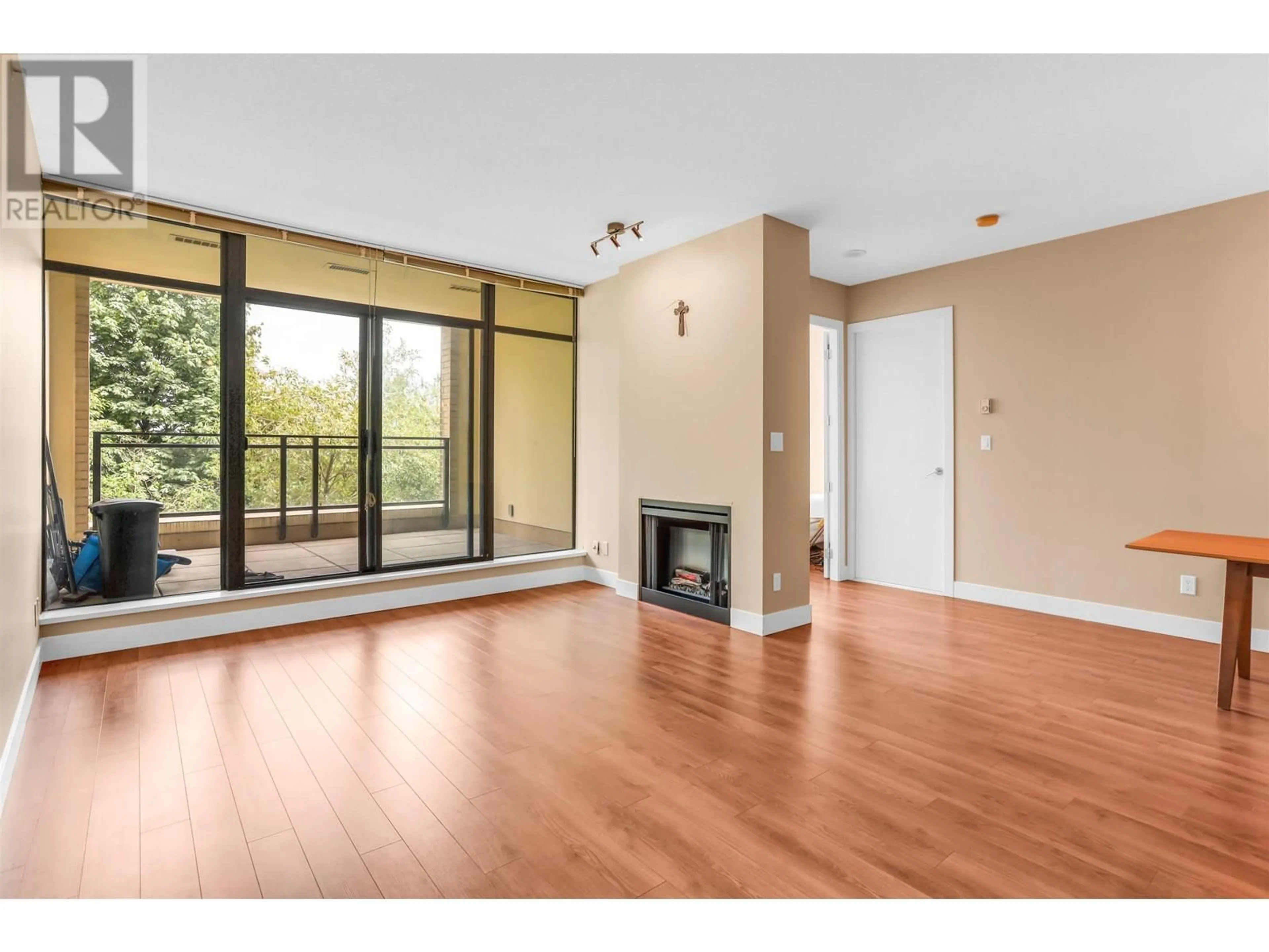 Living room with furniture, wood/laminate floor for 301 - 9310 UNIVERSITY CRESCENT, Burnaby British Columbia V5A4X9