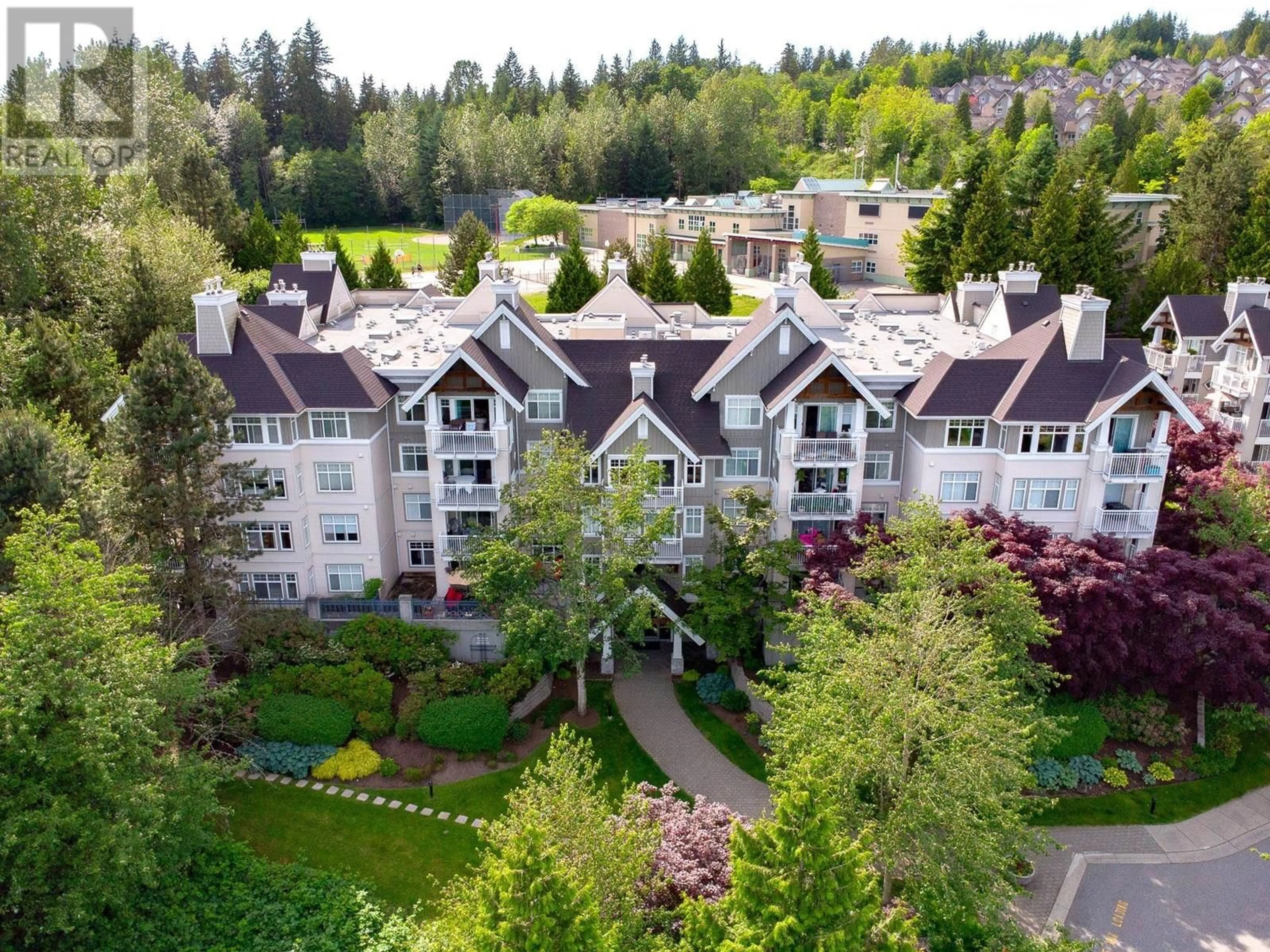 A pic from outside/outdoor area/front of a property/back of a property/a pic from drone, mountain view for 102 - 1438 PARKWAY BOULEVARD, Coquitlam British Columbia V3E3M1