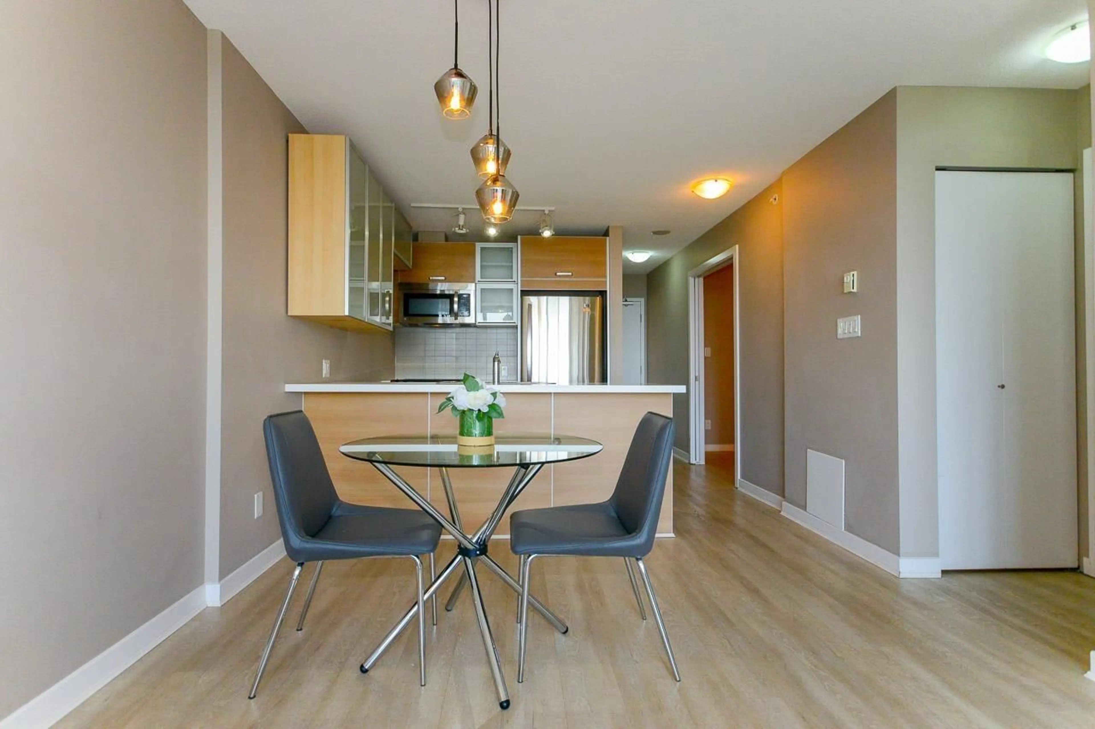 Open concept kitchen, wood/laminate floor for 2608 - 9981 WHALLEY, Surrey British Columbia V3T0G6