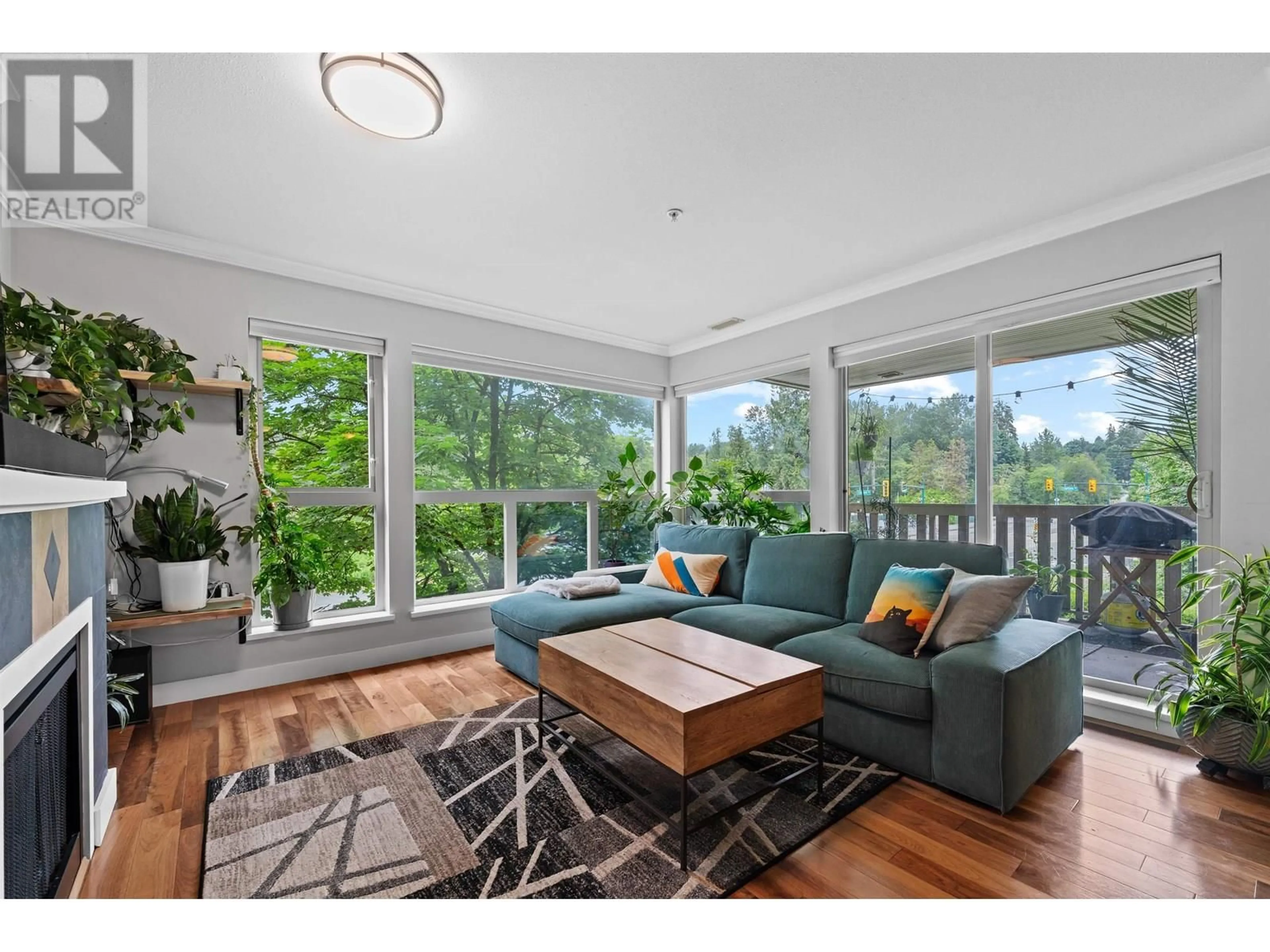 Living room with furniture, wood/laminate floor for 209 - 801 KLAHANIE DRIVE, Port Moody British Columbia V3H5K4